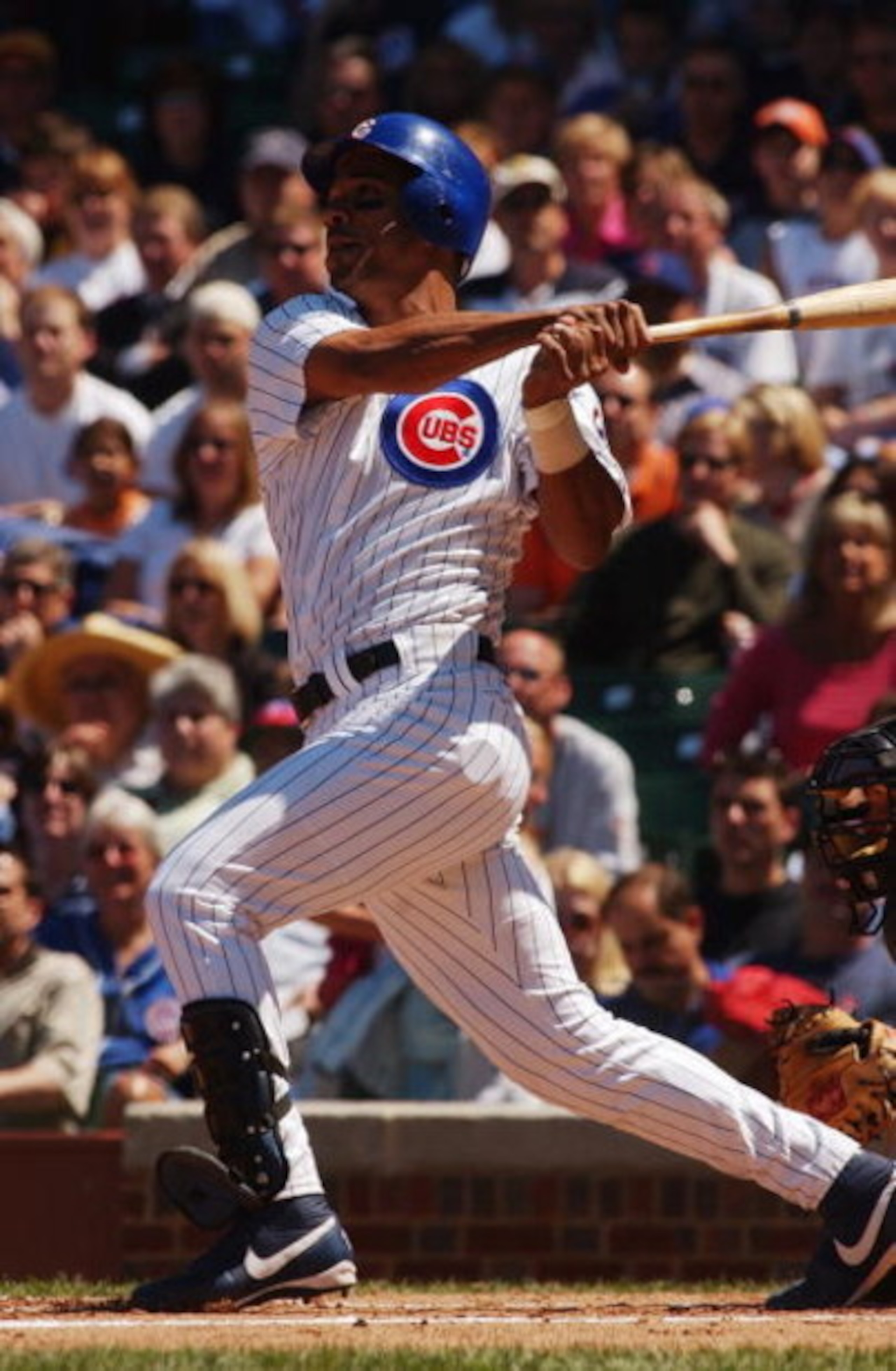 CHICAGO - JUNE 4:  Moises Alou #18 of the Chicago Cubs watches the flight of the ball as he follows through on a swing during the game against the Pittsburgh Pirates at Wrigley Field on June 4, 2004 in Chicago, Illinois. The Pirates defeated the Cubs 2-1.