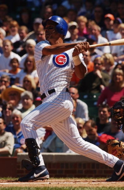 CHICAGO - JUNE 4:  Moises Alou #18 of the Chicago Cubs watches the flight of the ball as he follows through on a swing during the game against the Pittsburgh Pirates at Wrigley Field on June 4, 2004 in Chicago, Illinois. The Pirates defeated the Cubs 2-1.