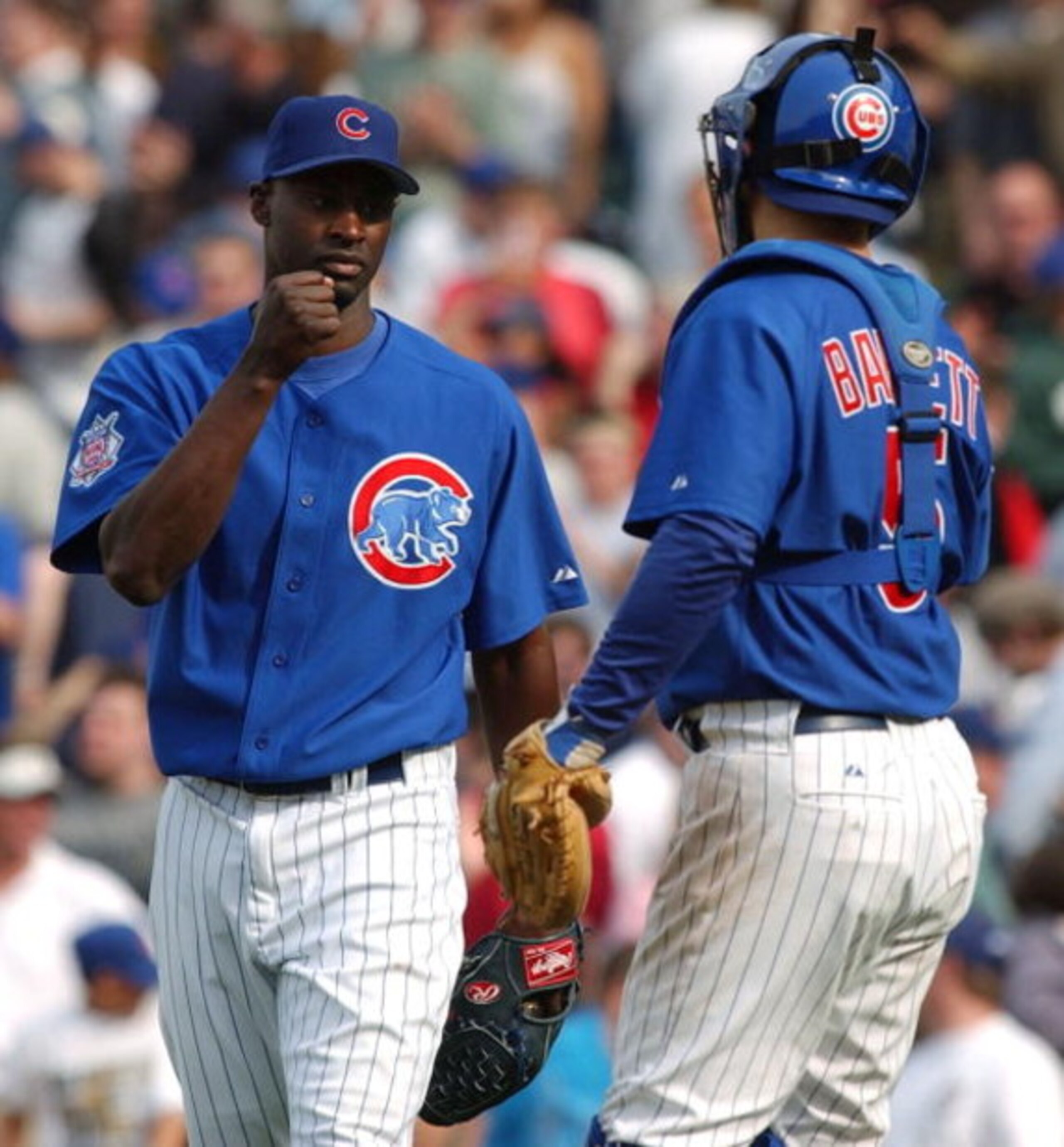 CHICAGO - APRIL 15: Relief pitcher LaTroy Hawkins #32 of the Chicago Cubs is congratulated by catcher Michael Barrett #5 after finishing the game against the Pittsburgh Pirates on April 15, 2004 at Wrigley Field in Chicago, Illinois. The Cubs defeated the