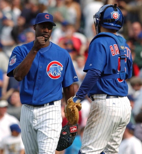 CHICAGO - APRIL 15: Relief pitcher LaTroy Hawkins #32 of the Chicago Cubs is congratulated by catcher Michael Barrett #5 after finishing the game against the Pittsburgh Pirates on April 15, 2004 at Wrigley Field in Chicago, Illinois. The Cubs defeated the