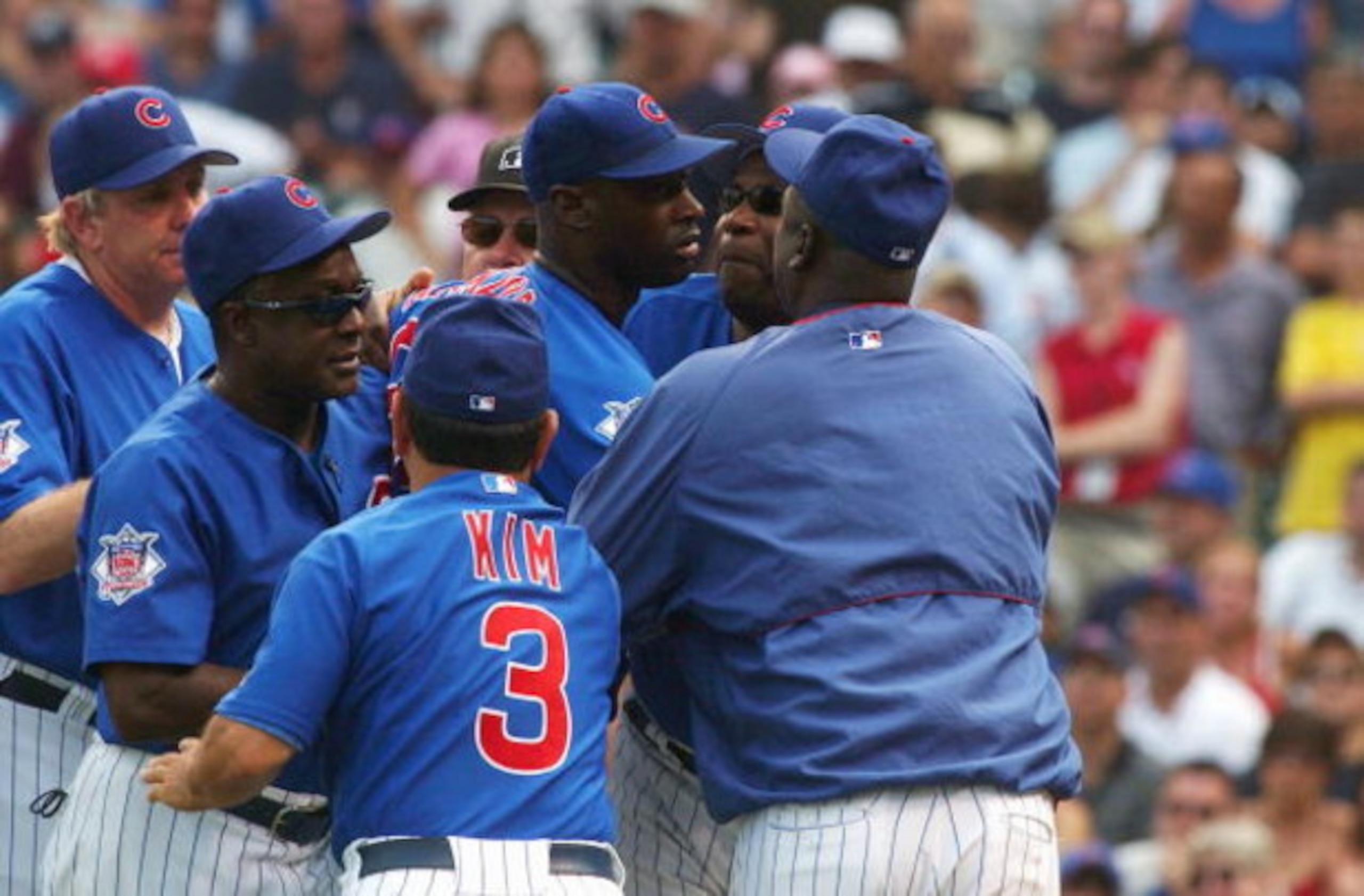CHICAGO - JULY 20:  Pitcher LaTroy Hawkins #32 (center) of the Chicago Cubs is restrained by members of the Chicago Cubs coaching staff including Wendell Kim #3 after being thrown out of a game during the ninth inning against the St. Louis Cardinals at Wr