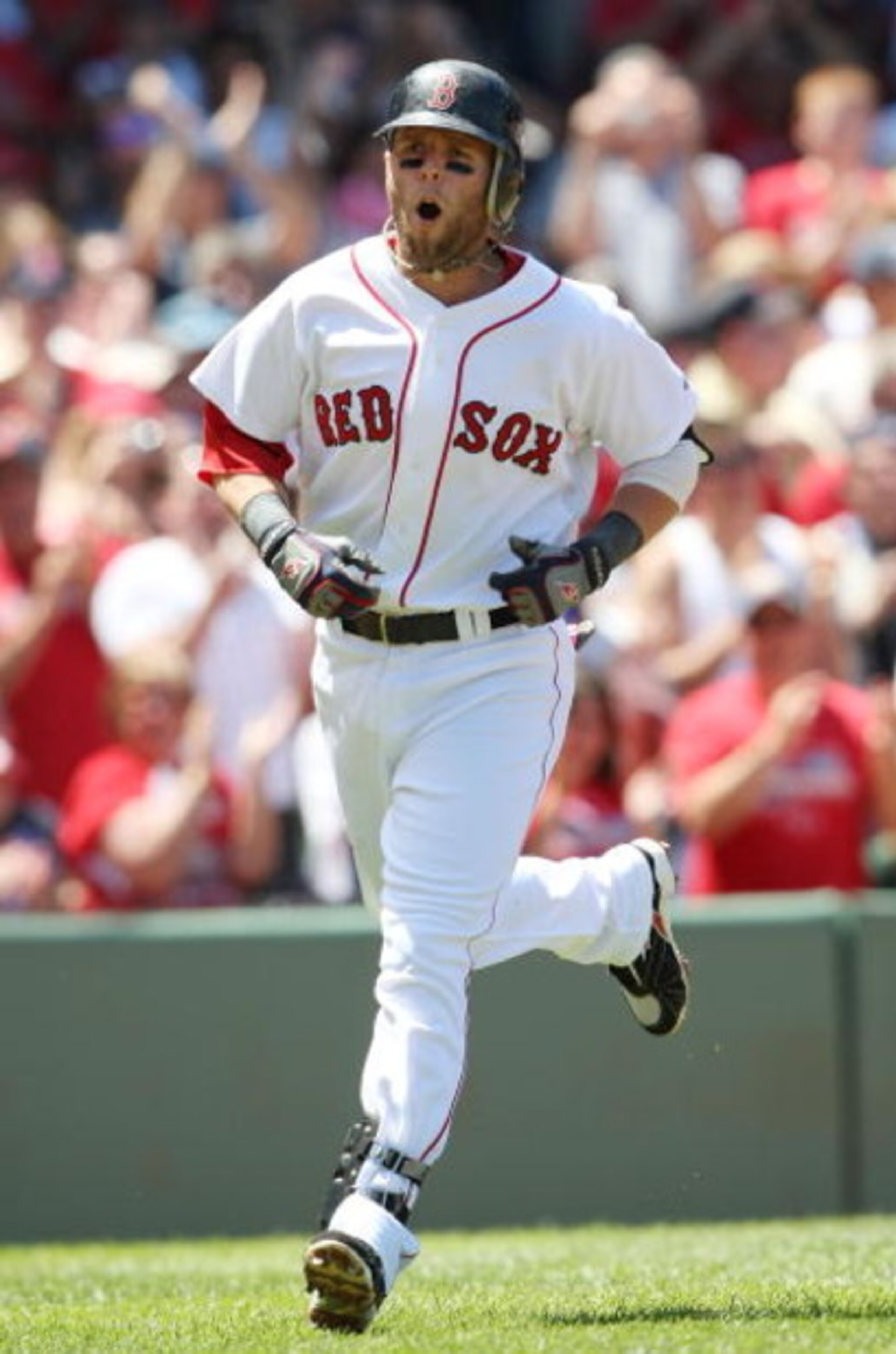 BOSTON - JULY 05:  Dustin Pedroia #15 of the Boston Red Sox celebrates his solo home run in the first inning against the Seattle Mariners on July 5, 2009 at Fenway Park in Boston, Massachusetts.  (Photo by Elsa/Getty Images)