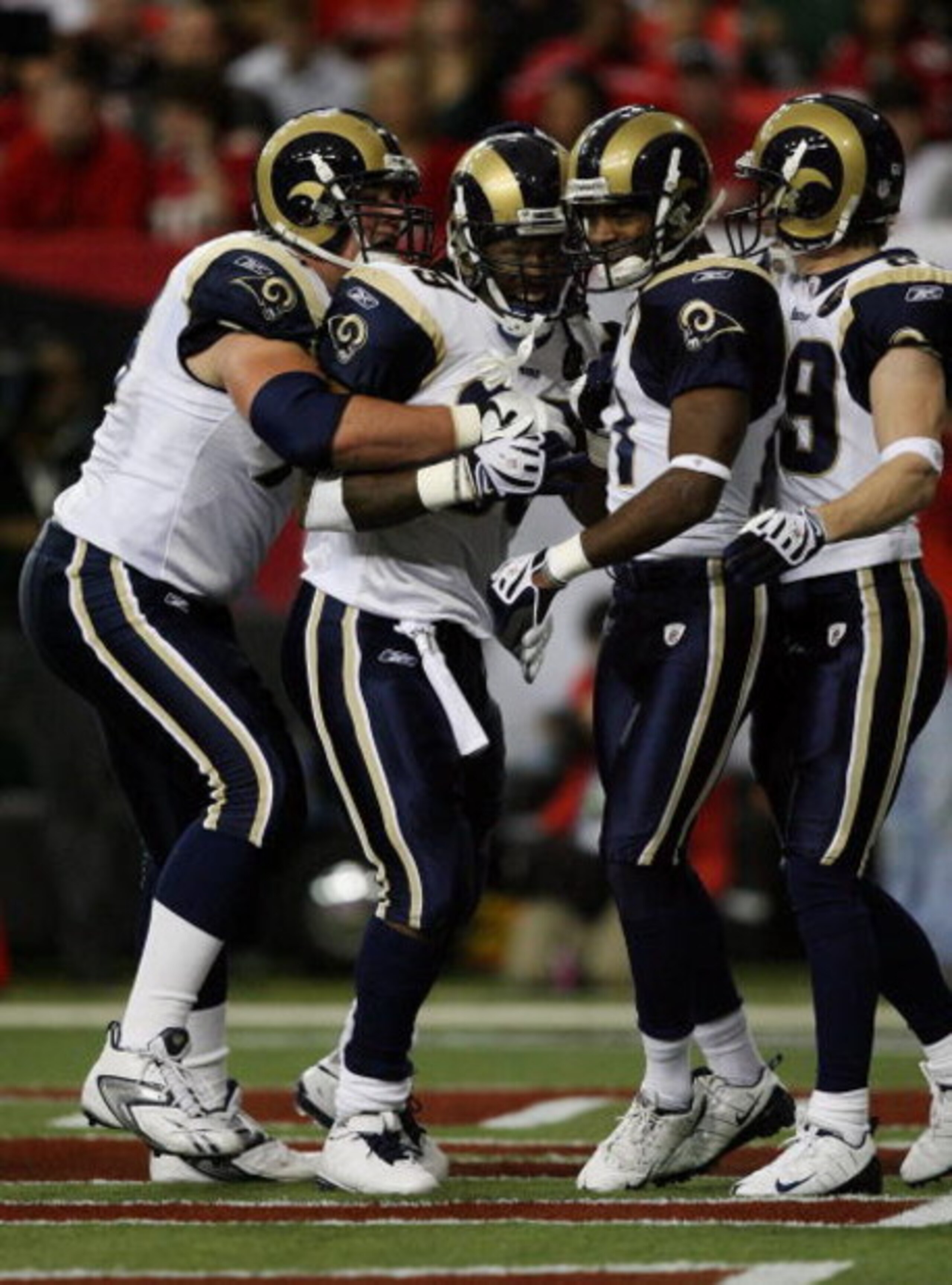 ATLANTA - DECEMBER 28:  Running back Steven Jackson #39 of the St. Louis Rams is congratulated by tackle Adam Goldberg #73, wide receivers Donnie Avery #17 and Dane Looker #89 after Jackson scored against the Atlanta Falcons at Georgia Dome on December 28
