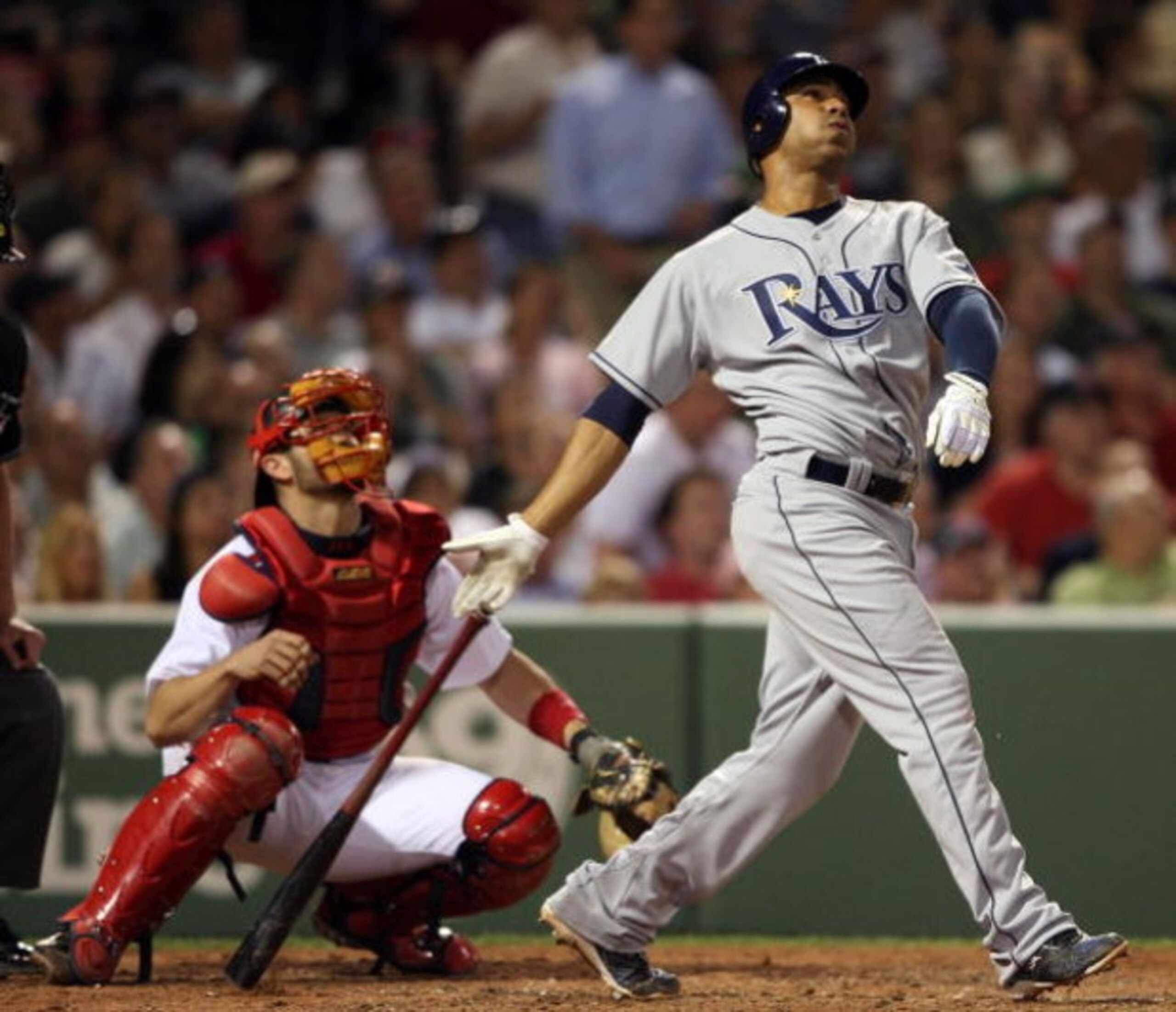 BOSTON - JUNE 03:  Carlos Pena #23 of the Tampa Bay Rays hits a two run homer in the sixth inning as Jason Varitek #33 of the Boston Red Sox catches on June 3, 2008 at Fenway Park in Boston, Massachusetts.  (Photo by Elsa/Getty Images)