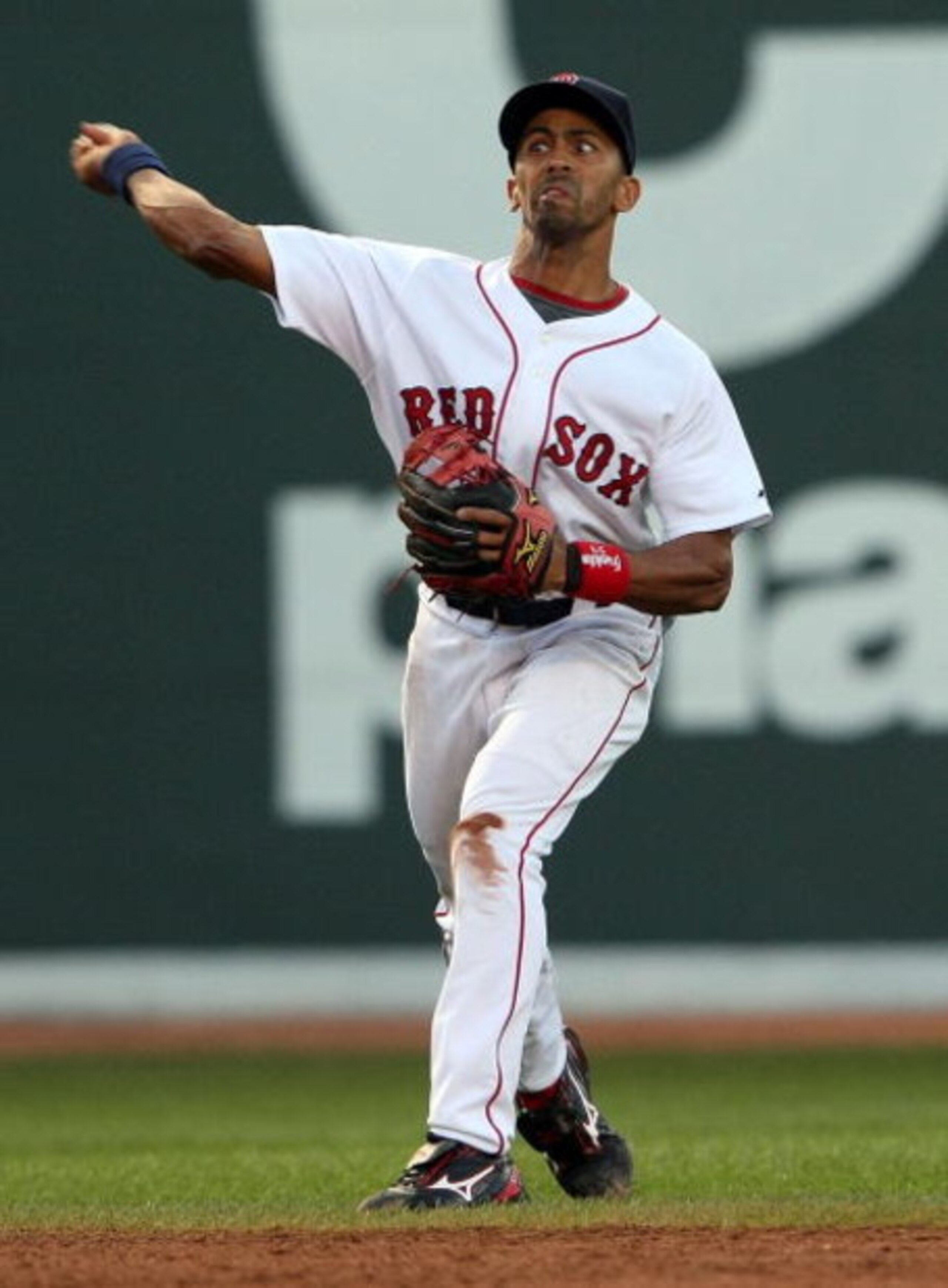 BOSTON - JULY 06:  Julio Lugo #23 of the Boston Red Sox over throws the ball to first base in the first inning against the Oakland Athletics on July 6, 2009 at Fenway Park in Boston, Massachusetts. The Athletics defeated the Red Sox 6-0. (Photo by Elsa/Ge