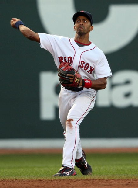 BOSTON - JULY 06:  Julio Lugo #23 of the Boston Red Sox over throws the ball to first base in the first inning against the Oakland Athletics on July 6, 2009 at Fenway Park in Boston, Massachusetts. The Athletics defeated the Red Sox 6-0. (Photo by Elsa/Ge