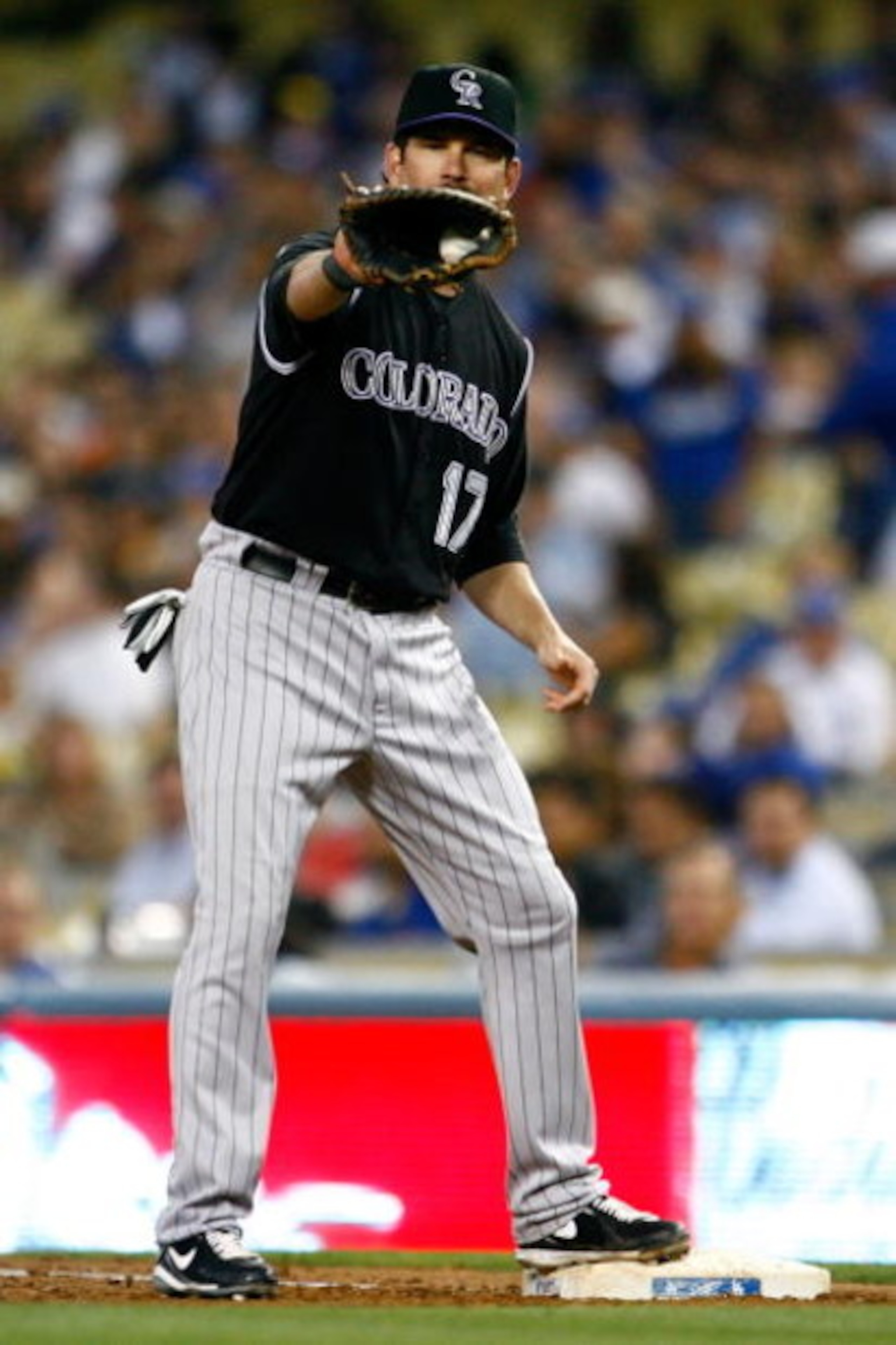 LOS ANGELES, CA - JUNE 30:  Todd Helton #17 of the Colorado Rockies catches the ball at first base for an out against the Los Angeles Dodgers at Dodger Stadium on June 30, 2009 in Los Angeles, California.  (Photo by Jeff Gross/Getty Images)