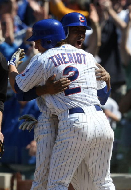 CHICAGO - MAY 16: Ryan Theriot #2 of the Chicago Cubs hugs teammate Bobby Scales #24 after Scales scored the game-winning run in the bottom of the 9th inning against the Houston Astros on May 16, 2009 at Wrigley Field in Chicago, Illinois. The Cubs defeat