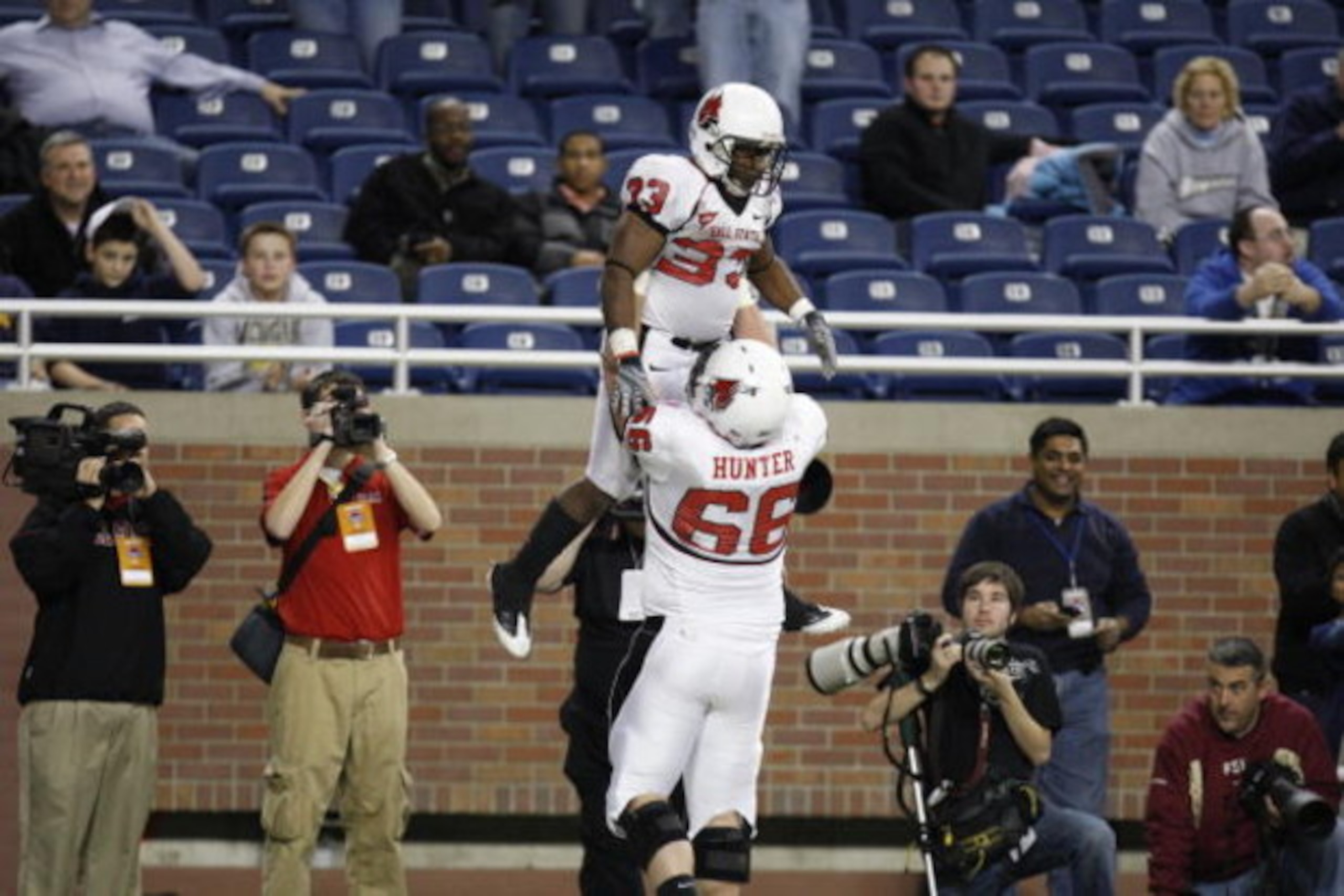 DETROIT - DECEMBER 5:  MiQuale Lewis #33 of the Ball State Cardinals is lifted in the air by teammate Kreg Hunger #66 as they celebrate against the Buffalo Bulls during the MAC Championship game on December 5, 2008 at Ford Field in Detroit Michigan. (Phot