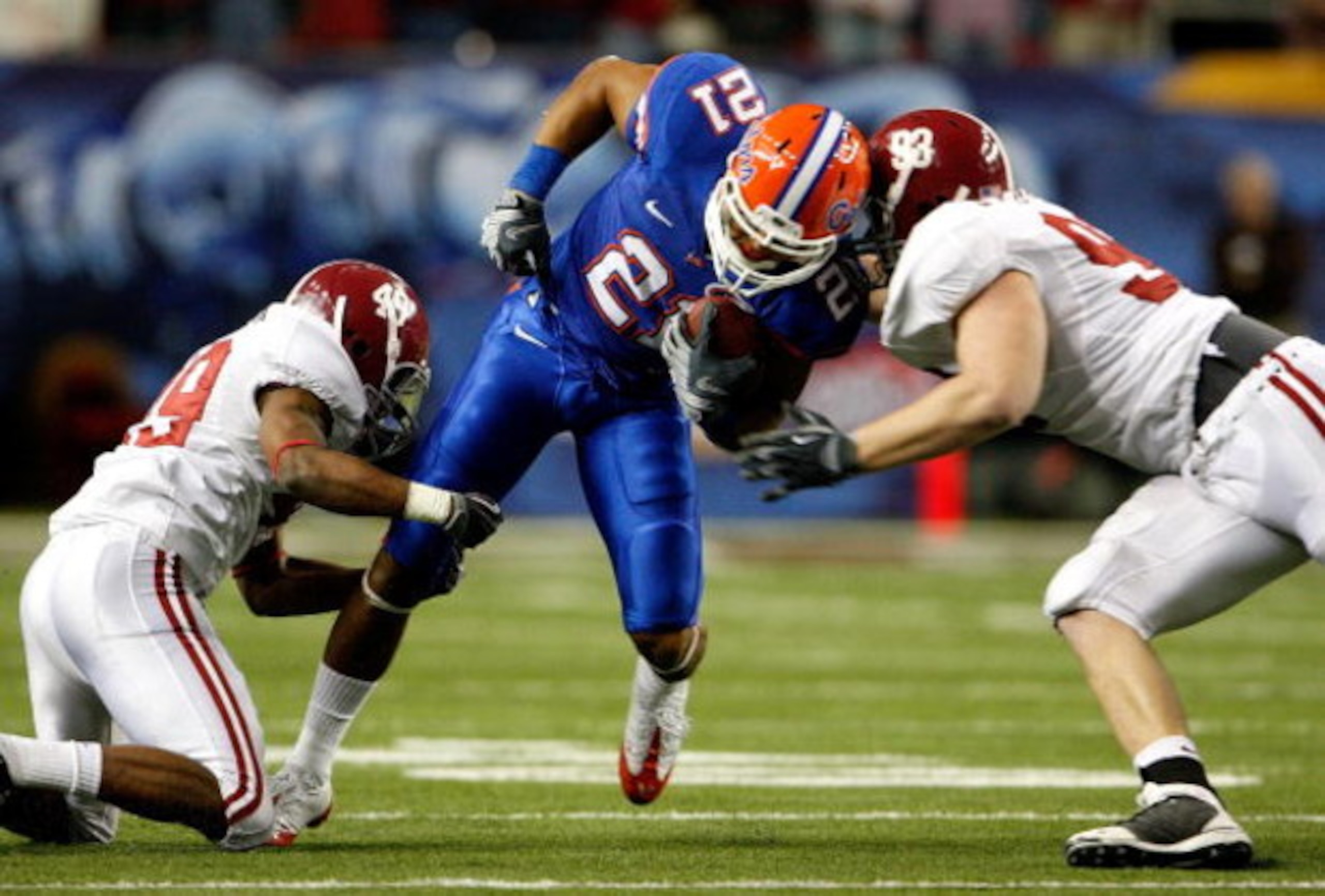 ATLANTA - DECEMBER 06:  Running back Emmanuel Moody #21 of the Florida Gators rushes between Rashad Johnson #49 and Bobby Greenwood #93 of the Alabama Crimson Tide during the SEC Championship on December 6, 2008 at the Georgia Dome in Atlanta, Georgia.  (
