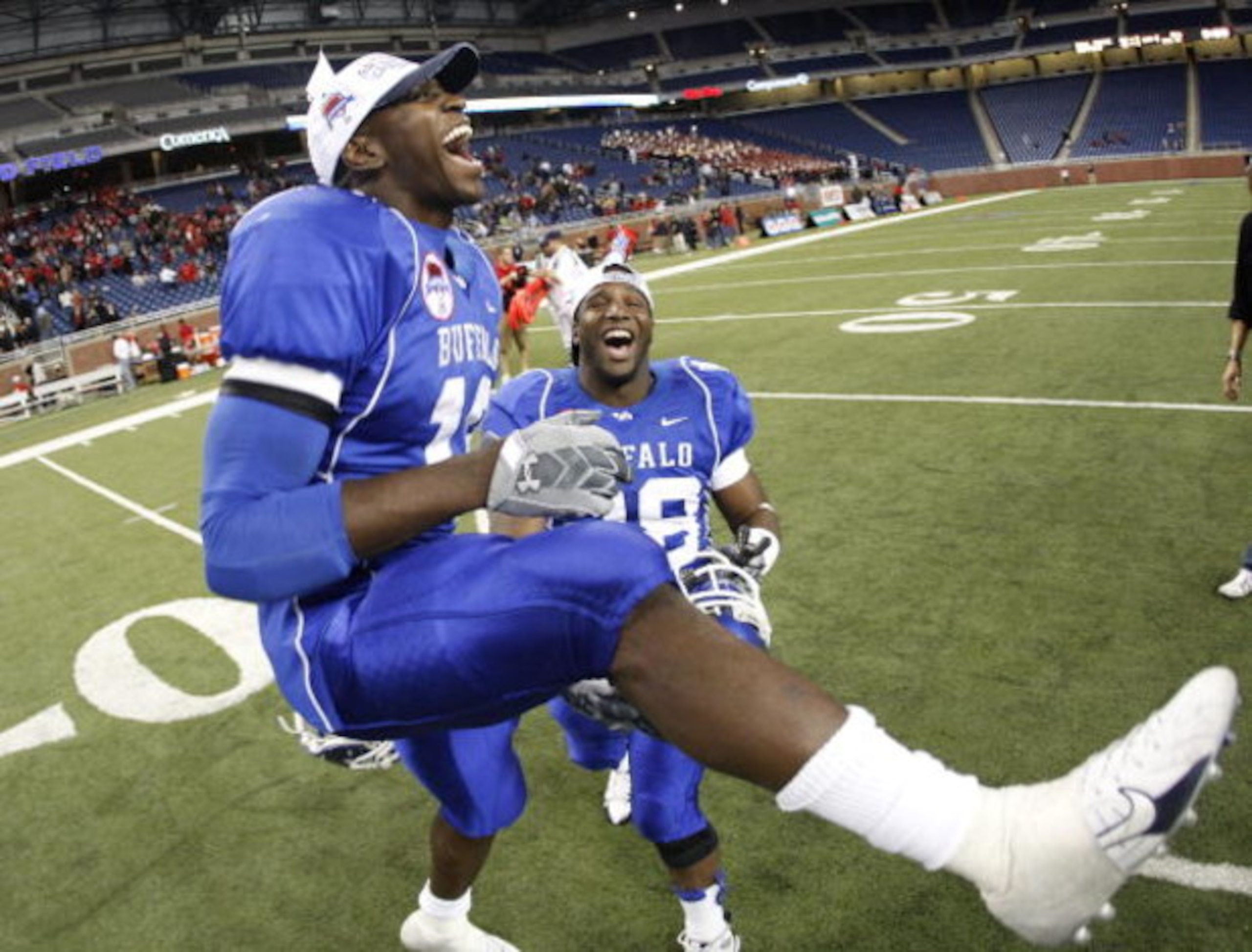 DETROIT - DECEMBER 05: James Starks #19 of the Buffalo Bulls celebrates the MAC Championship with Mario Henry #28 after defeating the Ball State Cardinals on December 5, 2008 at Ford Field in Detroit, Michigan. (Photo by Gregory Shamus/Getty Images)