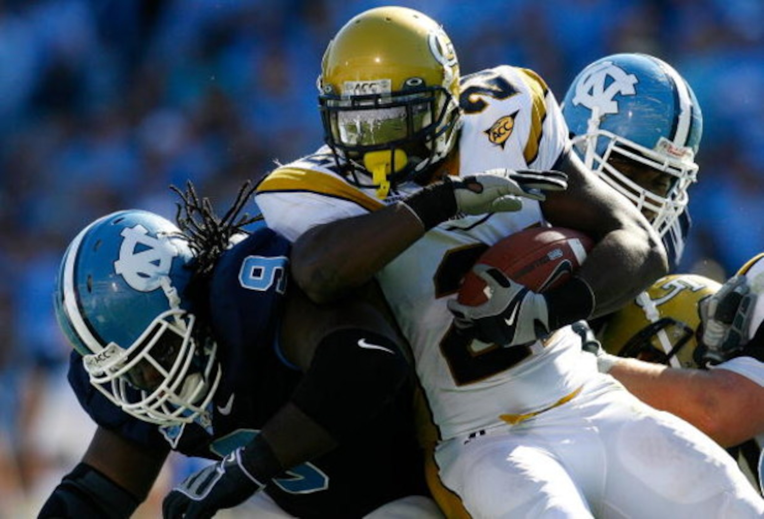 CHAPEL HILL, NC - NOVEMBER 08:  Running back Jonathan Dwyer #21 of the Georgia Tech Yellow Jackets runs into Marvin Austin #9 of the North Carolina Tar Heels during the game at Kenan Stadium on November 8, 2008 in Chapel Hill, North Carolina.  (Photo by K
