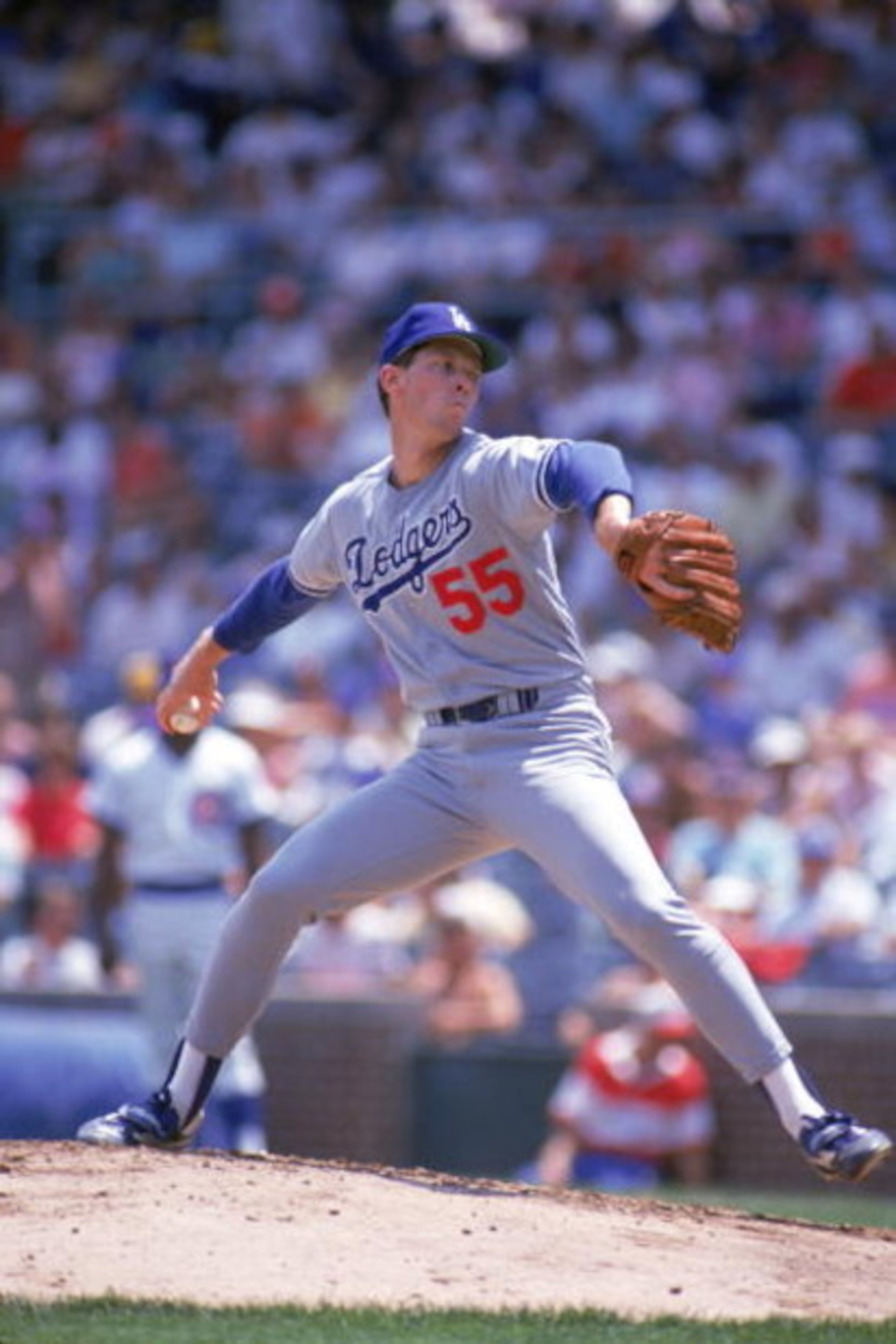 CHICAGO - 1987:  Orel Hershiser #55 of the Los Angeles Dodgers pitches against the Chicago Cubs in the 1987 season at Wrigley Field in Chicago, Illinois.  (Photo by Jonathan Daniel/Getty Images)