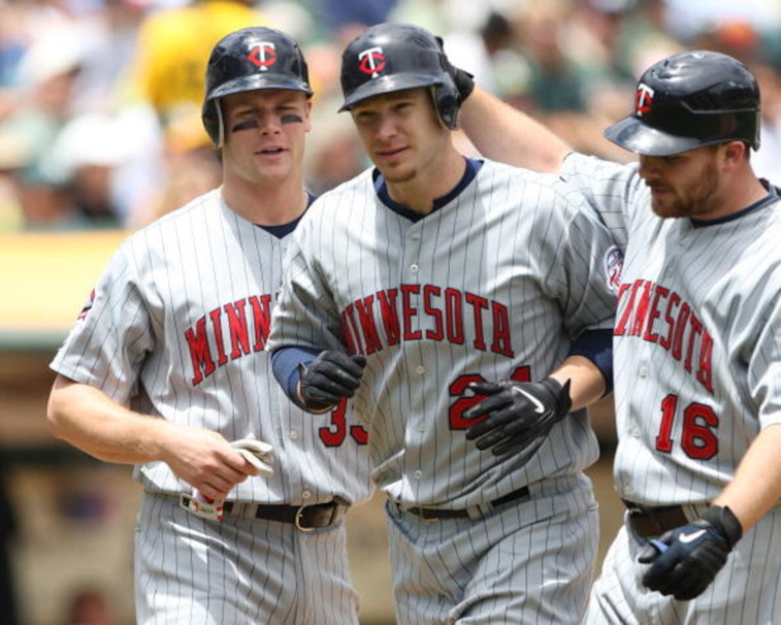 OAKLAND, CA - JUNE 11:  Joe Crede #24 of the Minnesota Twins is congratulated by Jason Kubel #16 and Justin Morneau #33 after hitting a home run in the fourth inning against the Oakland Athletics during a Major League Baseball game on June 11, 2009 at the