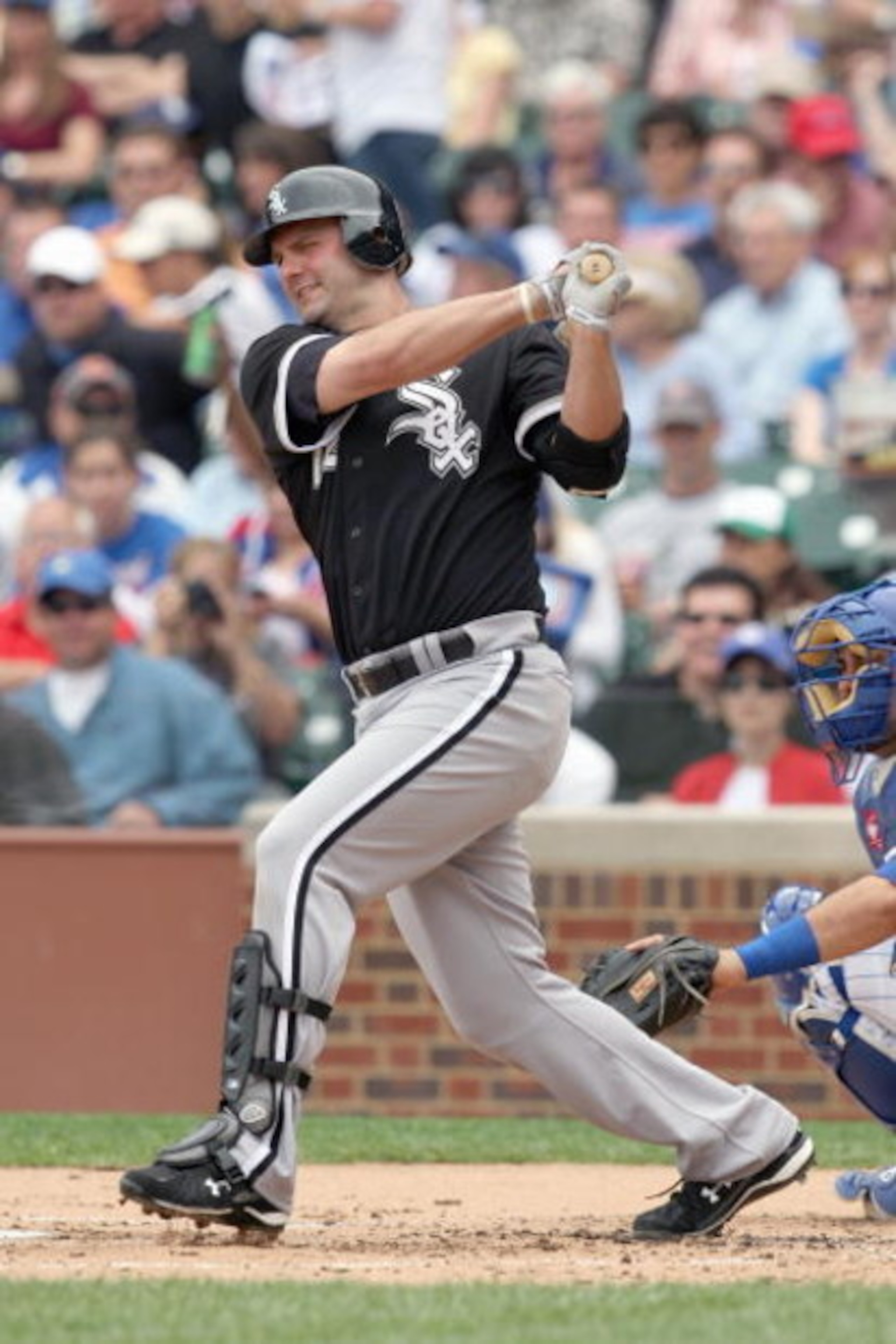 CHICAGO - JUNE 17: Paul Konerko #14 of the Chicago White Sox swings at the pitch against the Chicago Cubs on June 17, 2009 at Wrigley Field in Chicago, Illinois. (Photo by Jonathan Daniel/Getty Images)