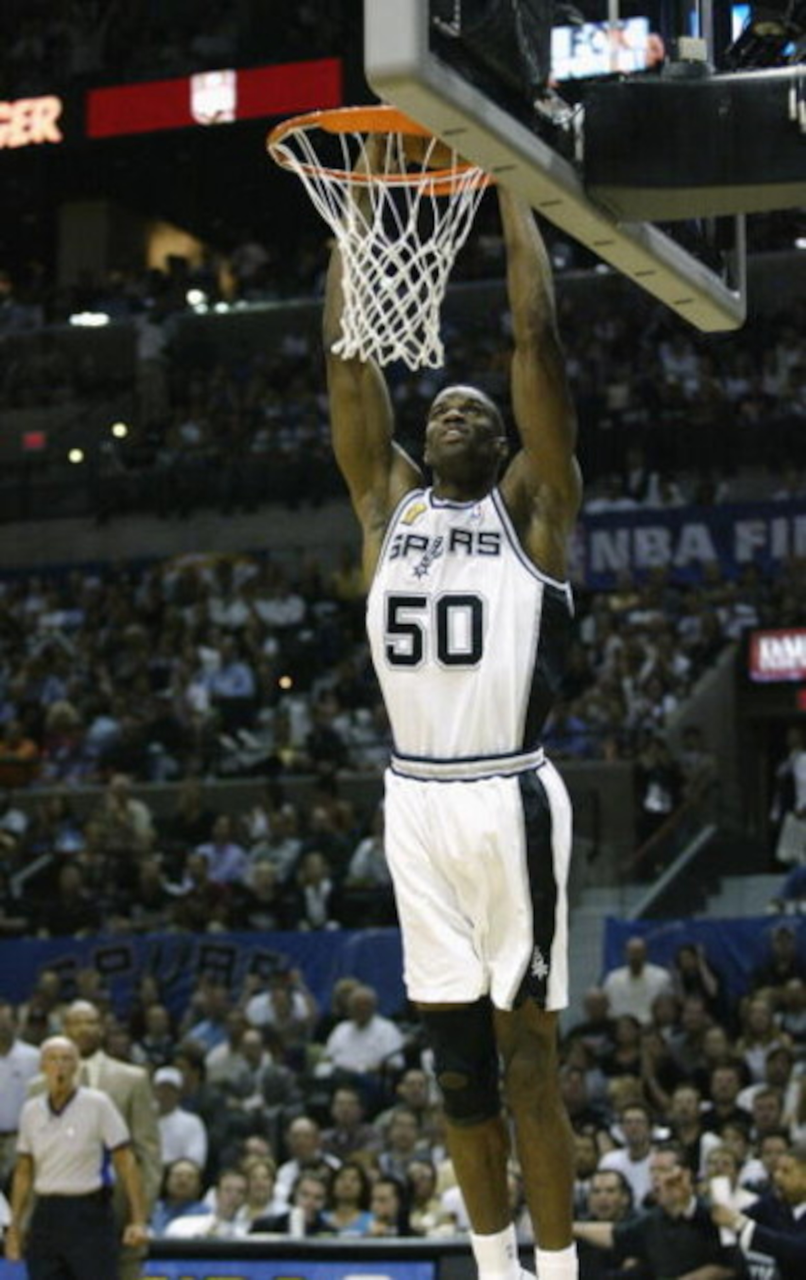 SAN ANTONIO - JUNE 4:  David Robinson #50 of the San Antonio Spurs goes up for a slam dunk in Game one of the 2003 NBA Finals against the New Jersey Nets at SBC Center on June 4, 2003 in San Antonio, Texas.  The Spurs won 101-89.  NOTE TO USER: User expre