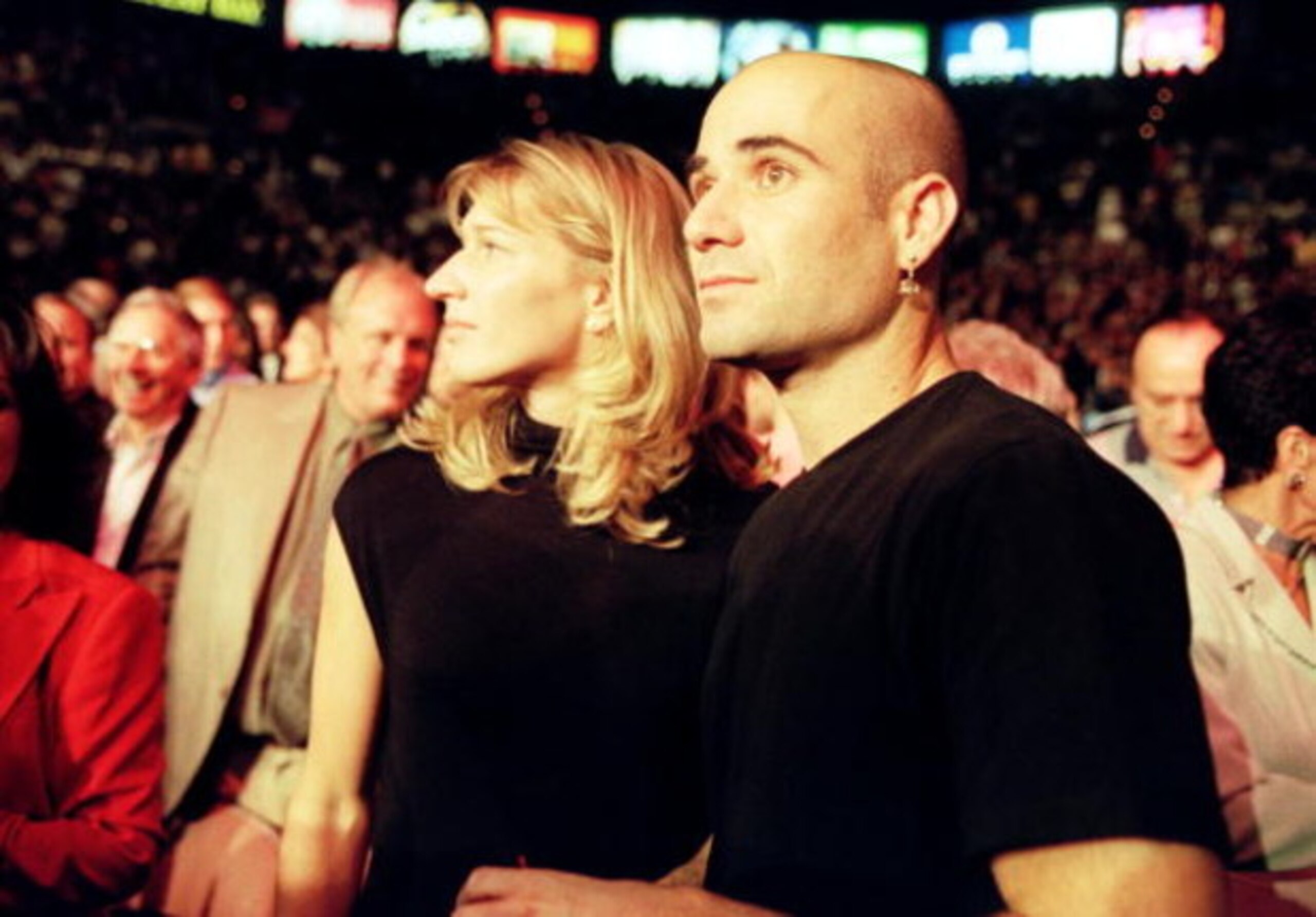 18 Sep 1999: Andre Agassi Stands In The Crowd With Steffi Graf By His Side During The Welterweight Title Fight Between Oscar De La Hoya And Felix Trinidad At The Mandalay Bay Casino In Las Vegas, Nevada. Trinidad Won The Fight By Decision. (Photo By Al Be
