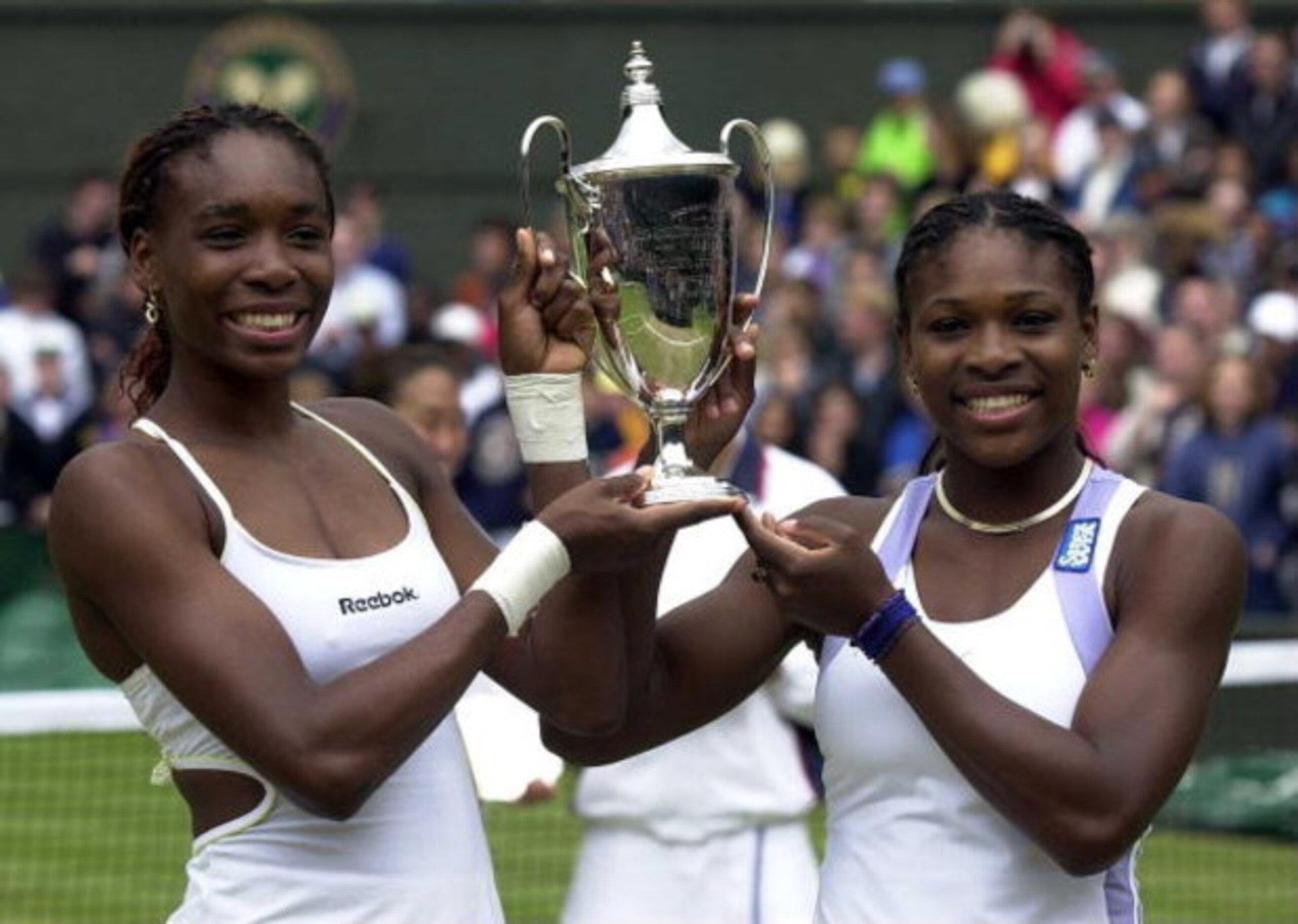 10 Jul 2000:  Venus and Serena Williams of the USA lift the winners trophy after the final of the womens doubles in the Wimbledon Lawn Tennis Championship at the All England Lawn Tennis and Croquet Club, Wimbledon, London. Mandatory Credit: Clive Brunskil