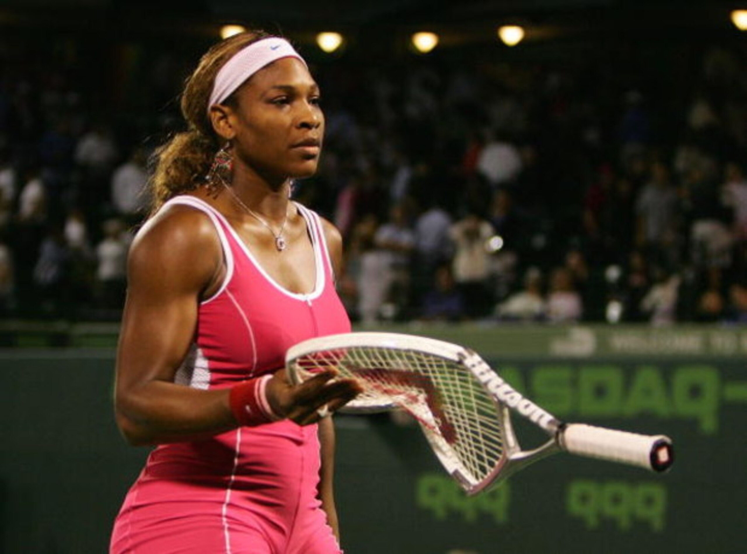 KEY BISCAYNE, FL - MARCH 29:  Serena Williams holds her broken racket after losing to Venus Williams 6-1, 7-6 during the NASDAQ 100 Open on March 29, 2005 in Key Biscayne, Florida.  (Photo by Al Bello/Getty Images)