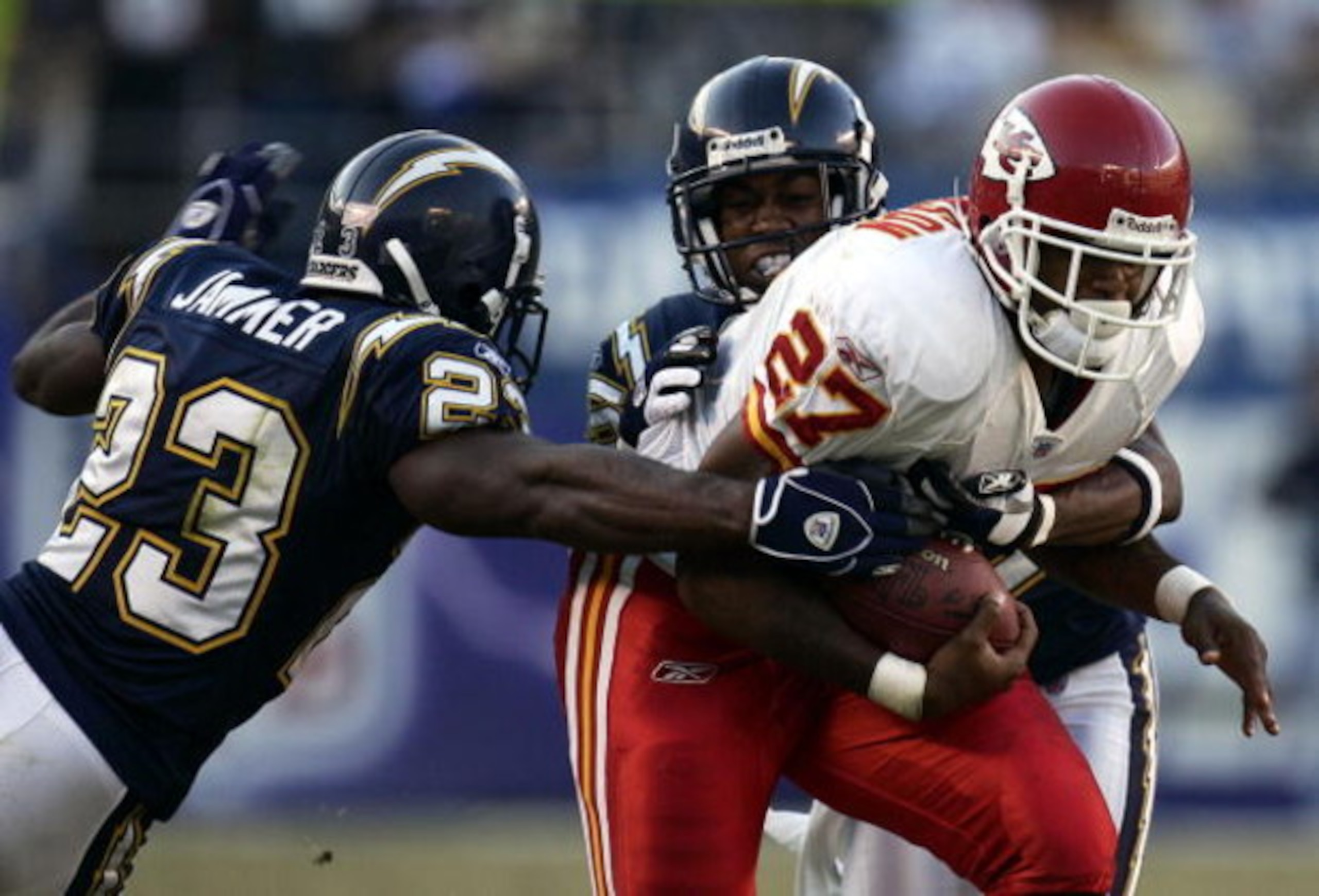 SAN DIEGO - OCTOBER 30:  Running back Larry Johnson #27 of the Kansas City Chiefs is tackled by Quentin Jammer #23 and Jamar Fletcher #25 of the San Diego Chargers during the 4th quarter of their NFL Game on October 30, 2005 at Qualcomm Stadium in San Die