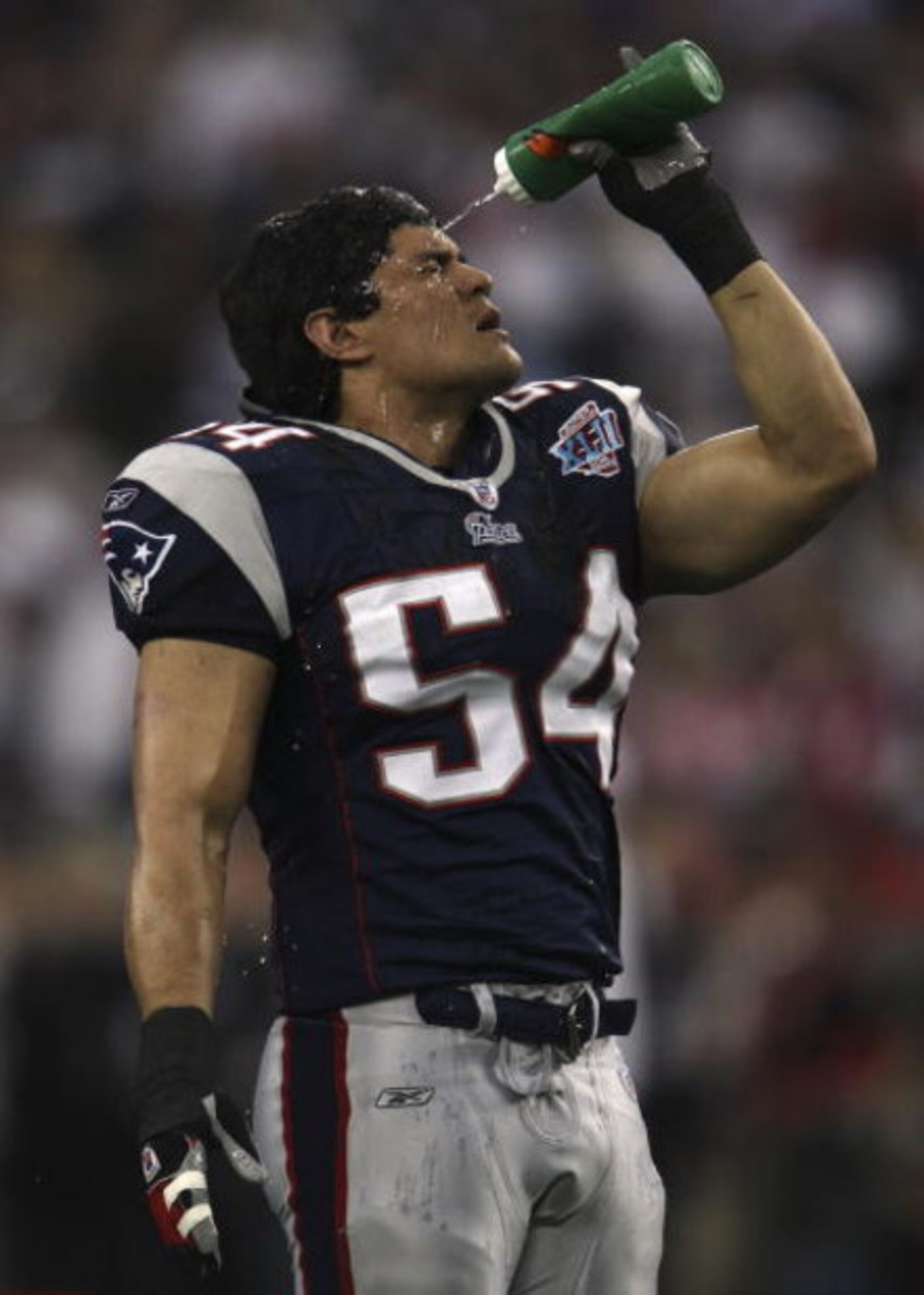 GLENDALE, AZ - FEBRUARY 03:  Tedy Bruschi #54 of the New England Patriots sprays water on his face during warmups against the New York Giants during Super Bowl XLII on February 3, 2008 at the University of Phoenix Stadium in Glendale, Arizona.  (Photo by 