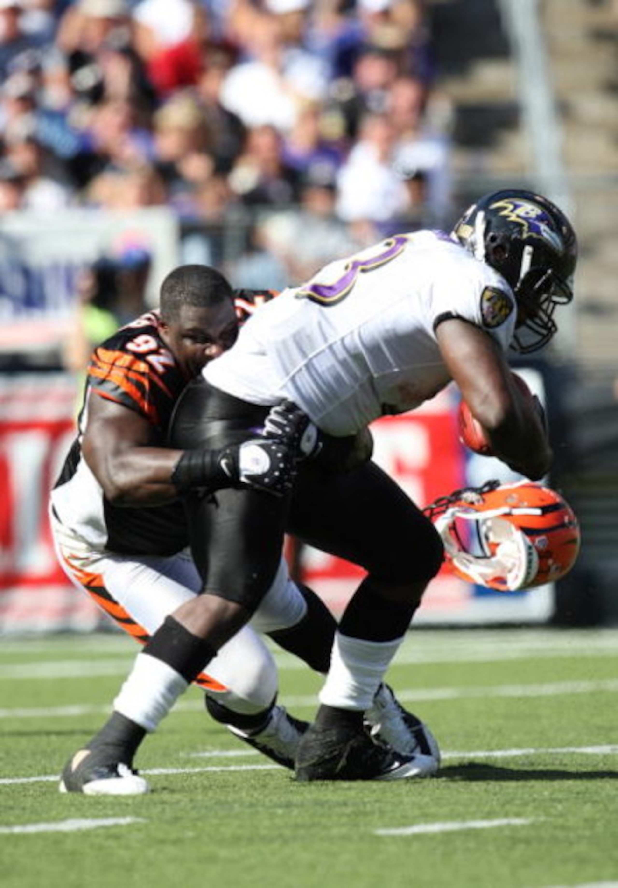 BALTIMORE - SEPTEMBER 7: Defensive end Frostee Rucker #92 of the Cincinnati Bengals makes a tackle against running back Le'Ron McClain #33 of the Baltimore Ravens at M&T Bank Stadium on September 7, 2008 in Baltimore, Maryland. The Ravens won 17-10. (Phot
