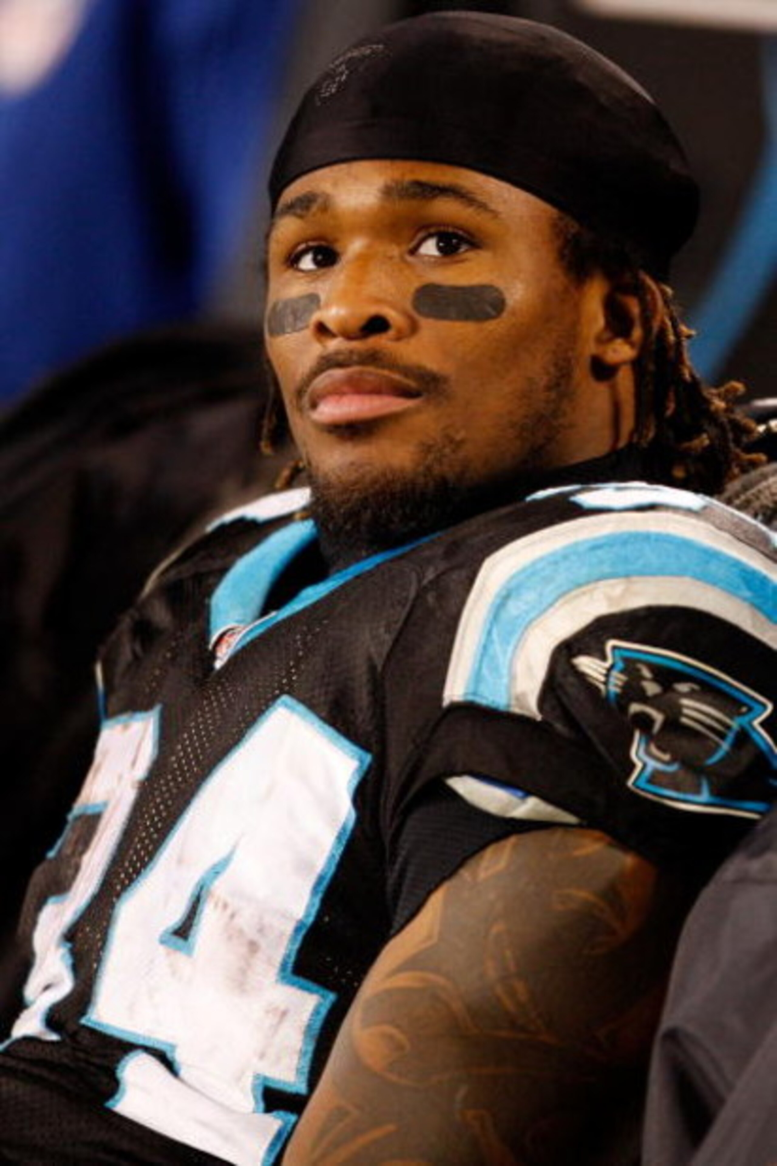 CHARLOTTE, NC - JANUARY 10:  DeAngelo Williams #34 of the Carolina Panthers look on from the bench in the fourth quarter of the game against the Arizona Cardinals during the NFC Divisional Playoff Game on January 10, 2009 at Bank of America Stadium in Cha