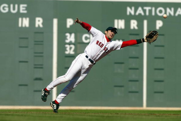 BOSTON - OCTOBER 5:  Shortstop Nomar Garciaparra #5 of the Boston Red Sox dives for a ball hit by Jose Guillen of the Oakland Athletics in game four of the American League Division Series on October 5, 2003 at Fenway Park in Boston, Massachusetts. Garciap