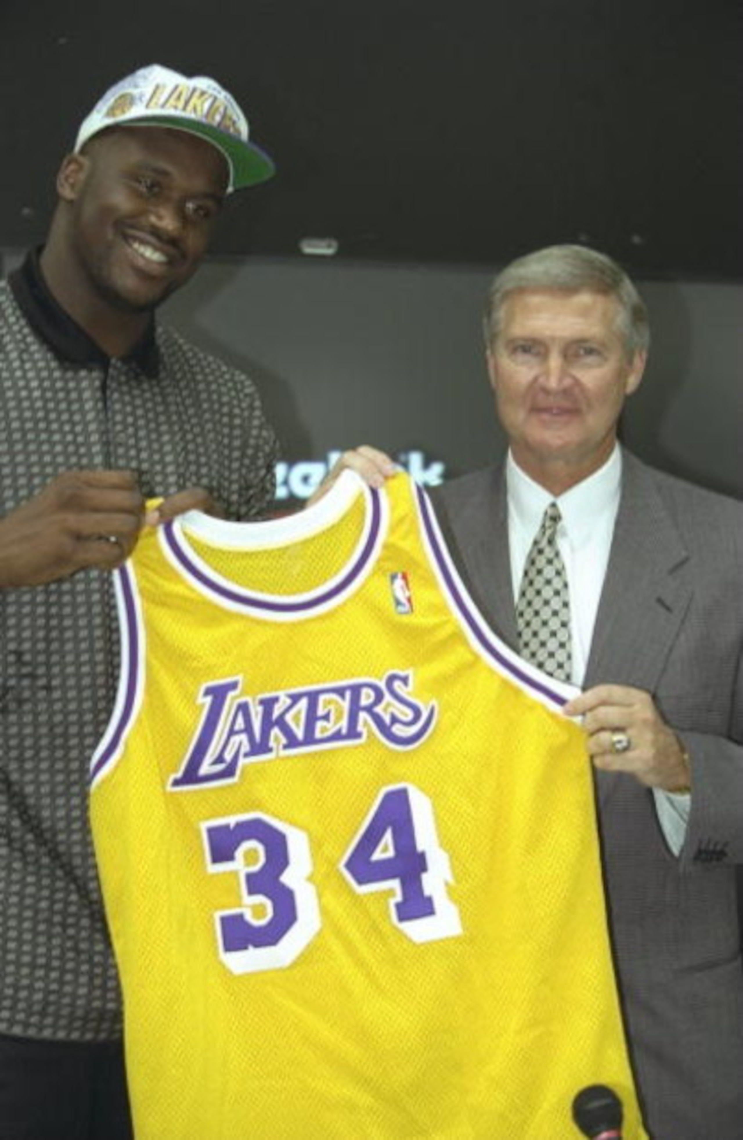 18 Jul 1996:  Center Shaquille O''Neal (left) poses with Los Angeles Lakers General Manager Jerry West and his new Lakers jersey during a press conference at the Media Press Center in Atlanta, Georgia.  Mandatory Credit: Jed Jacobson/Allsport