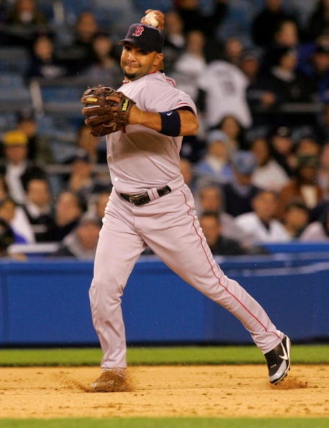 NEW YORK - MAY 09:  Alex Gonzalez #11 of the Boston Red Sox fields a ball against the New York Yankees on May 9, 2006 at Yankee Stadium in the Bronx borough of New York City.  (Photo by Jim McIsaac/Getty Images)