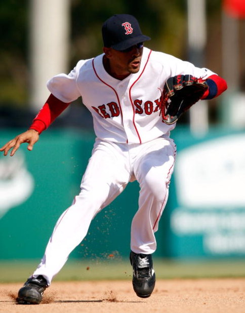 FORT MYERS, FL - MARCH 02:  Shortstop Julio Lugo #23 of the Boston Red Sox makes a play on the ball against the Minnesota Twins during the game on March 2, 2008 at City of Palms Park in Ft. Myers, Florida.  (Photo by J. Meric/Getty Images)