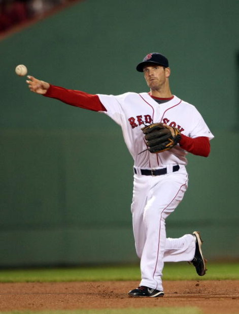 BOSTON - JULY 07:  Nick Green #22 of the Boston Red Sox sends the ball to first for the out against the Oakland Athletics on July 7, 2009 at Fenway Park in Boston, Massachusetts.  (Photo by Elsa/Getty Images)