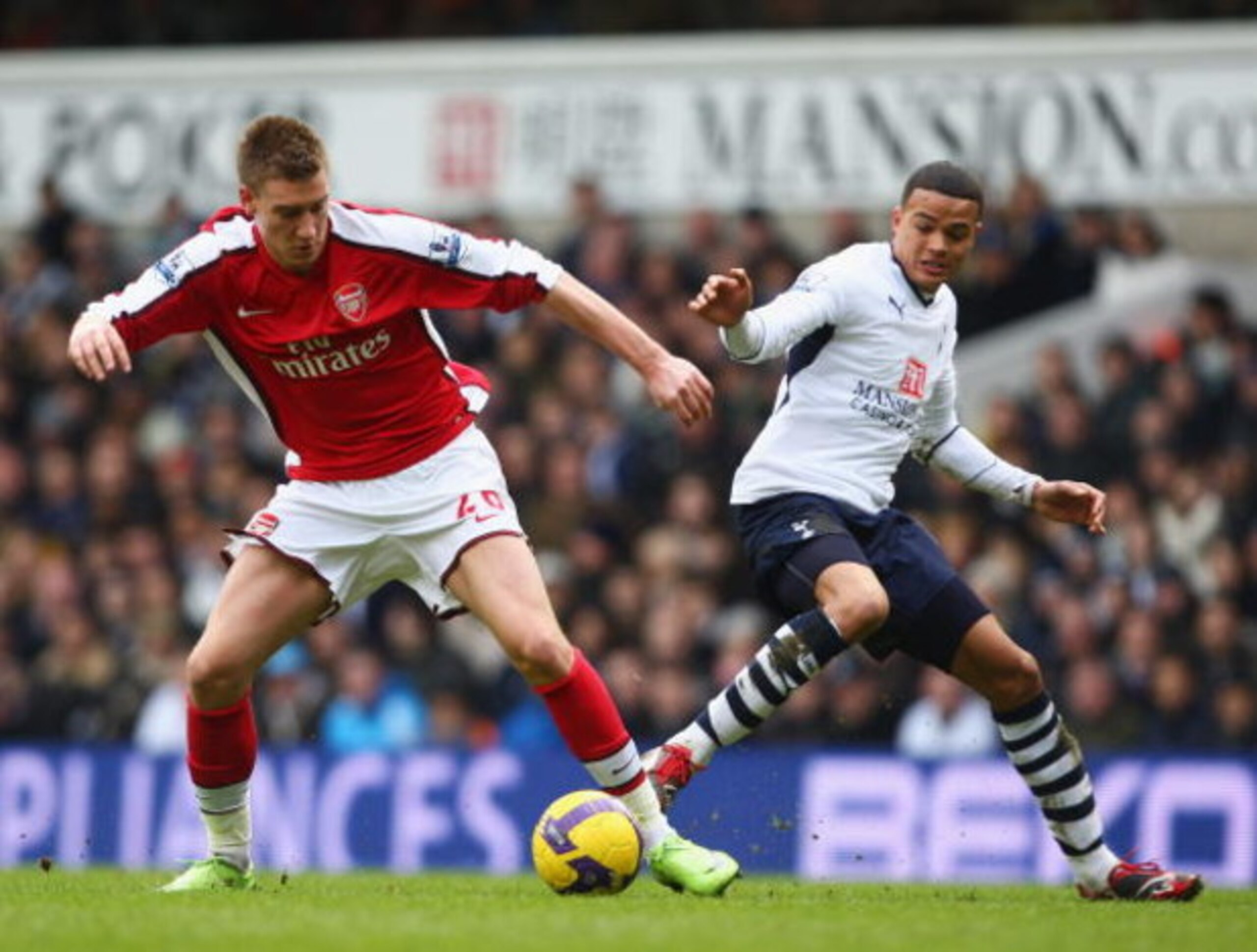LONDON - FEBRUARY 08:  Nicklas Bendtner of Arsenal skips past Jermain Jenas of Tottenham Hotspur during the Barclays Premier League match between Tottenham Hotspur and Arsenal at White Hart Lane on February 8, 2009 in London, England.  (Photo by Mike Hewi