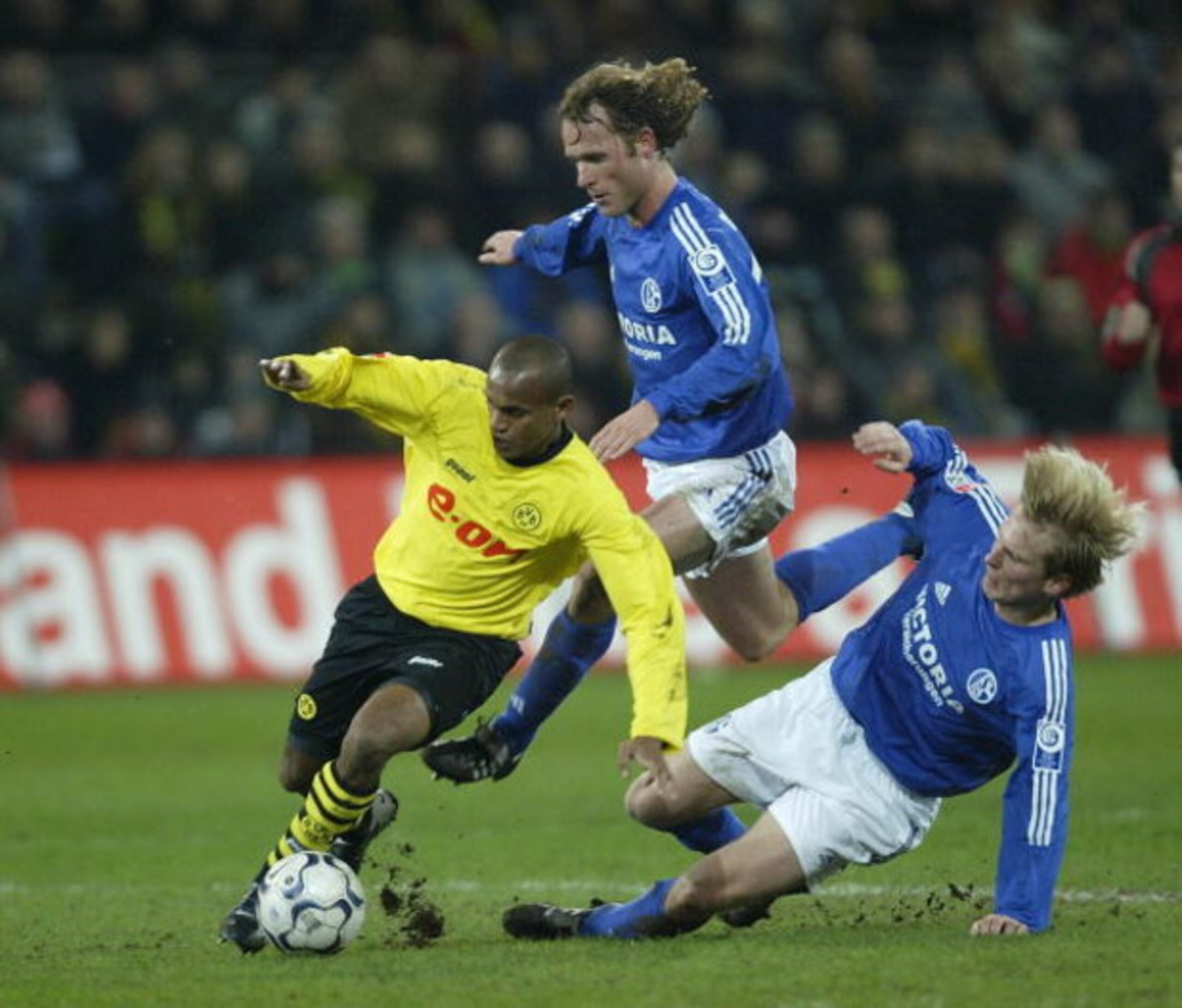 DORTMUND, GERMANY - JANUARY 30: Ewerthon of Dortmund in action against Neil Oude Kamphuis and Christain Poulsen of Schalke during the Bundsliga match between Borussia Dortmund and  FC Schalke 04 at The Westfallen Stadium on 30 January, 2004 in Dortmund, G