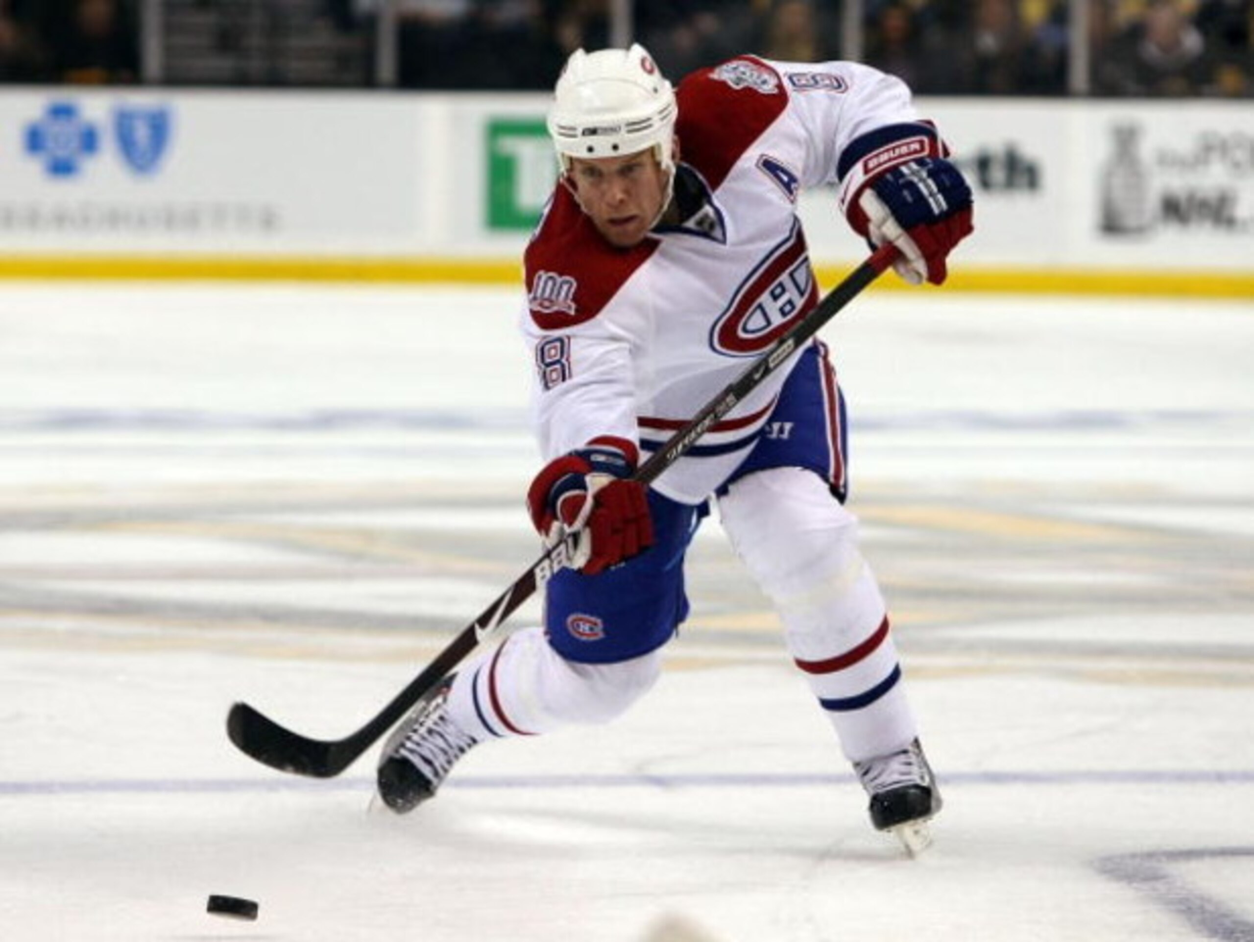 BOSTON - APRIL 16:  Mike Komisarek #8 of the Montreal Canadiens passes the puck against the Boston Bruins during Game 1 of the Eastern Conference quarterfinals of the 2009 Stanley Cup playoffs on April 16, 2009 at the TD Banknorth Garden in Boston, Massac