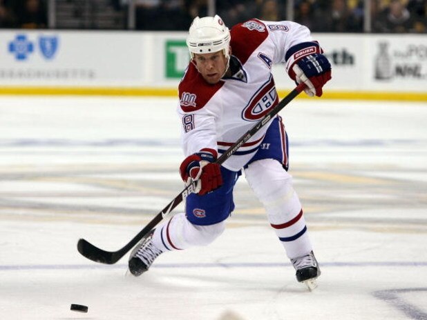 BOSTON - APRIL 16:  Mike Komisarek #8 of the Montreal Canadiens passes the puck against the Boston Bruins during Game 1 of the Eastern Conference quarterfinals of the 2009 Stanley Cup playoffs on April 16, 2009 at the TD Banknorth Garden in Boston, Massac