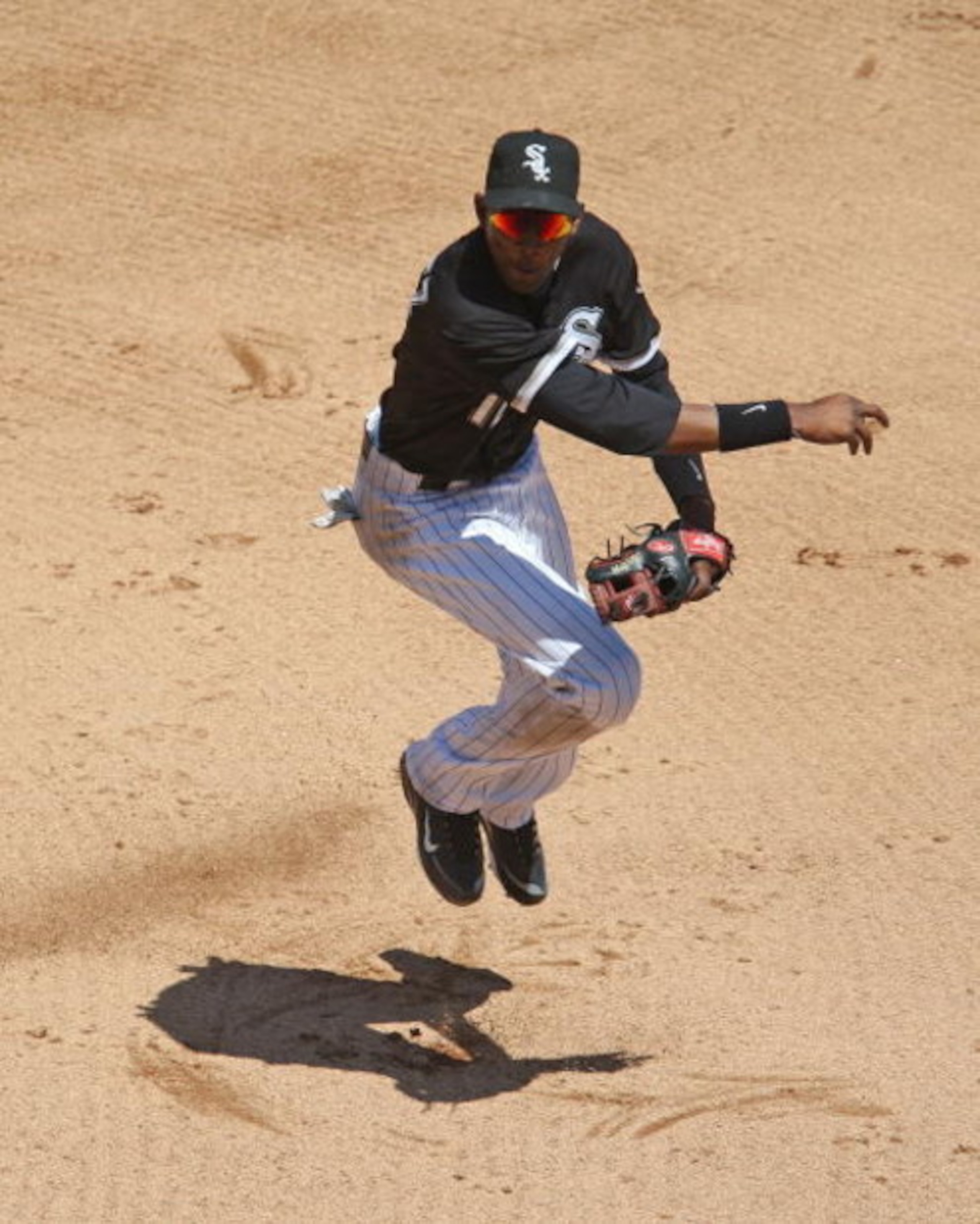CHICAGO - JUNE 28: Alexei Ramirez #10 of the Chicago White Sox hops after throwing the ball to first base on a double play against the Chicago Cubs on June 28, 2009 at U.S. Cellular Field in Chicago, Illinois. The White Sox defeated the Cubs 6-0. (Photo b CHICAGO - JUNE 28: Alexei Ramirez #10 of the Chicago White Sox hops after throwing the ball to first base on a double play against the Chicago Cubs on June 28, 2009 at U.S. Cellular Field in Chicago, Illinois. The White Sox defeated the Cubs 6-0. (Photo b