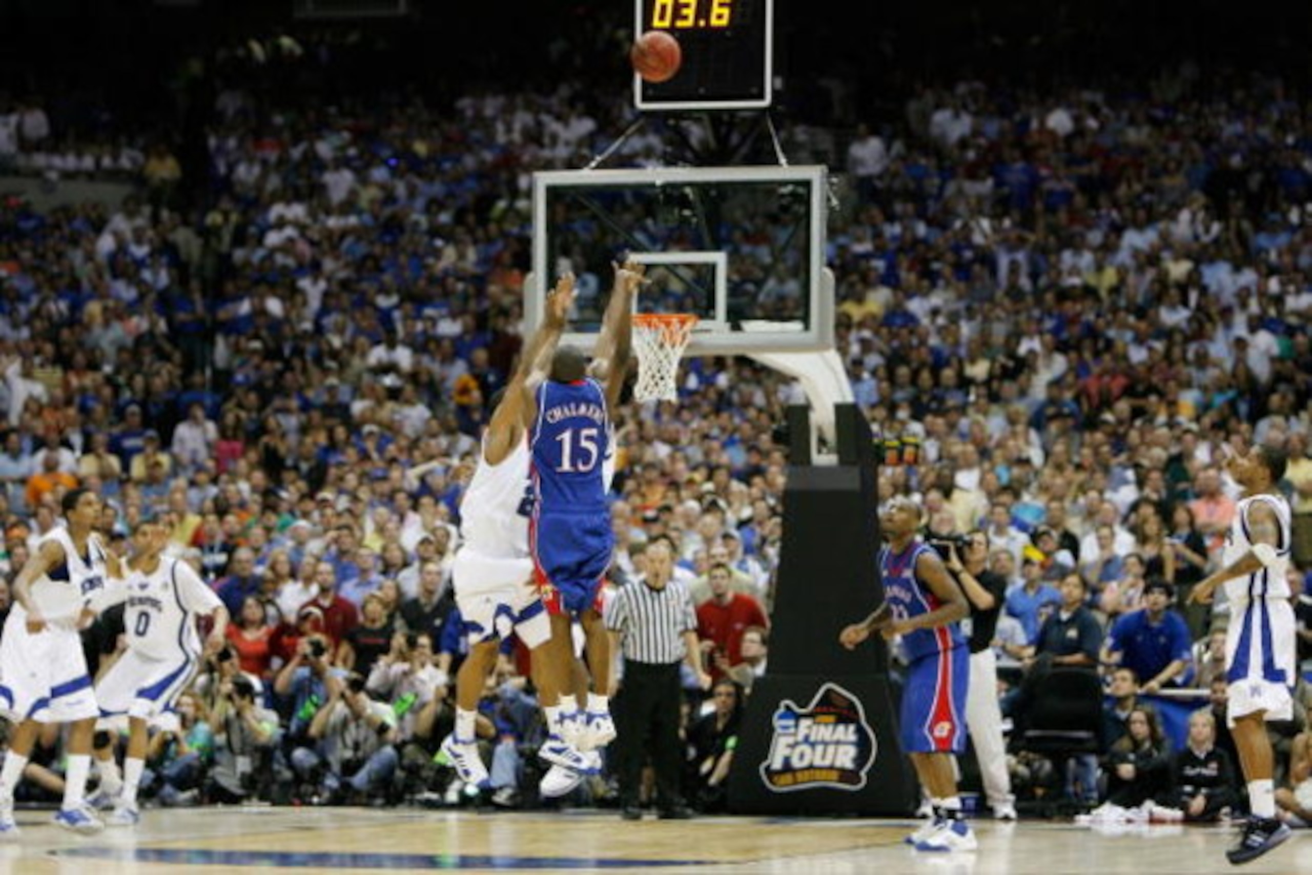 SAN ANTONIO - APRIL 07:  Mario Chalmers #15 of the Kansas Jayhawks shoots and makes a three-pointer to tie the game to send it into overtime against the Memphis Tigers during the 2008 NCAA Men's National Championship game at the Alamodome on April 7, 2008