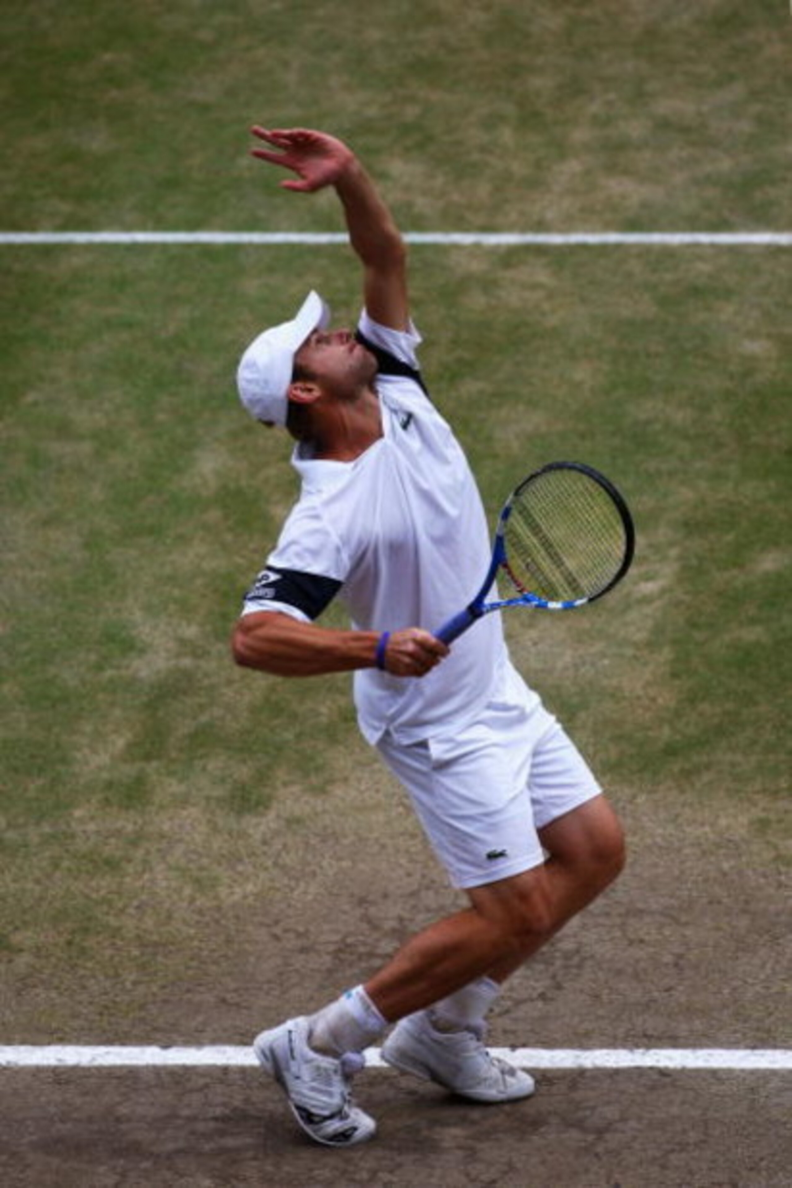 WIMBLEDON, ENGLAND - JULY 05:  Andy Roddick of USA serves during the men's singles final match against Roger Federer of Switzerland on Day Thirteen of the Wimbledon Lawn Tennis Championships at the All England Lawn Tennis and Croquet Club on July 5, 2009 