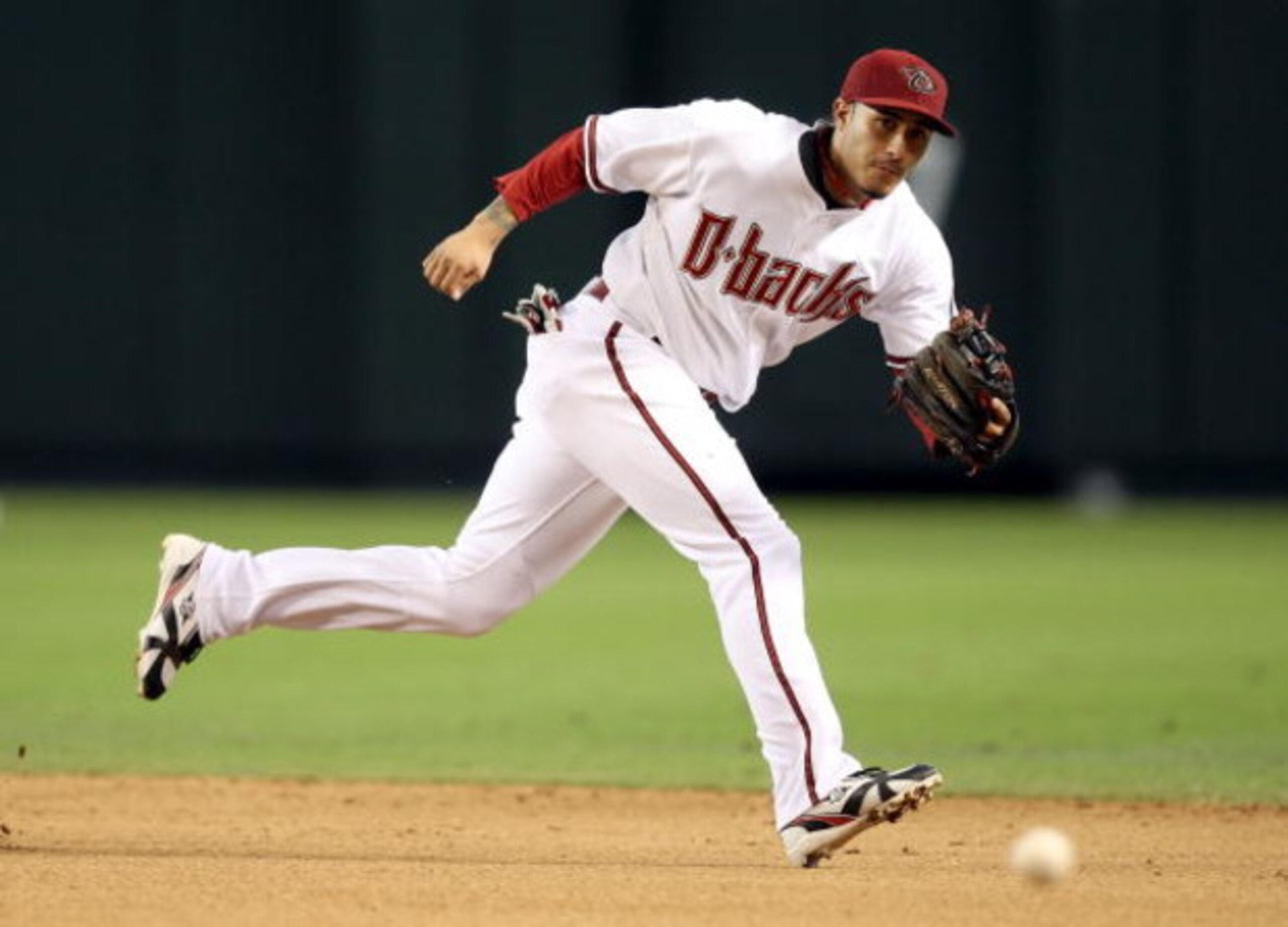 PHOENIX - JULY 08:  Infielder Felipe Lopez #2 of the Arizona Diamondbacks attempts to field a single hit by the San Diego Padres during the major league baseball game at Chase Field on July 8, 2009 in Phoenix, Arizona.  The Diamondbacks defeated the Padre