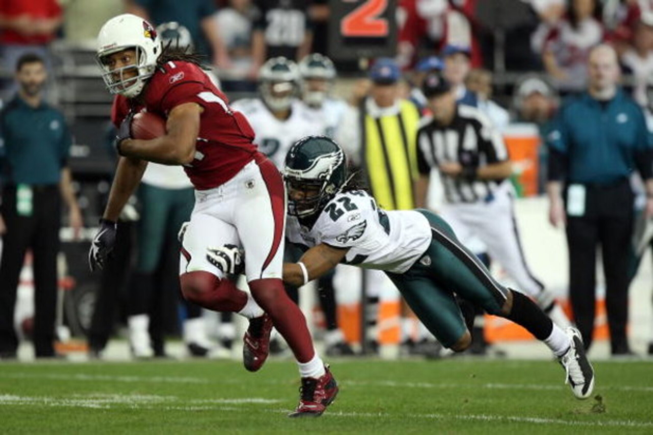 GLENDALE, AZ - JANUARY 18: Wide receiver Larry Fitzgerald #11 of the Arizona Cardinals attempts to run by a tackle attempt by cornerback Asante Samuel #22 of the Philadelphia Eagles during the NFC championship game on January 18, 2009 at University of Ph GLENDALE, AZ - JANUARY 18: Wide receiver Larry Fitzgerald #11 of the Arizona Cardinals attempts to run by a tackle attempt by cornerback Asante Samuel #22 of the Philadelphia Eagles during the NFC championship game on January 18, 2009 at University of Ph