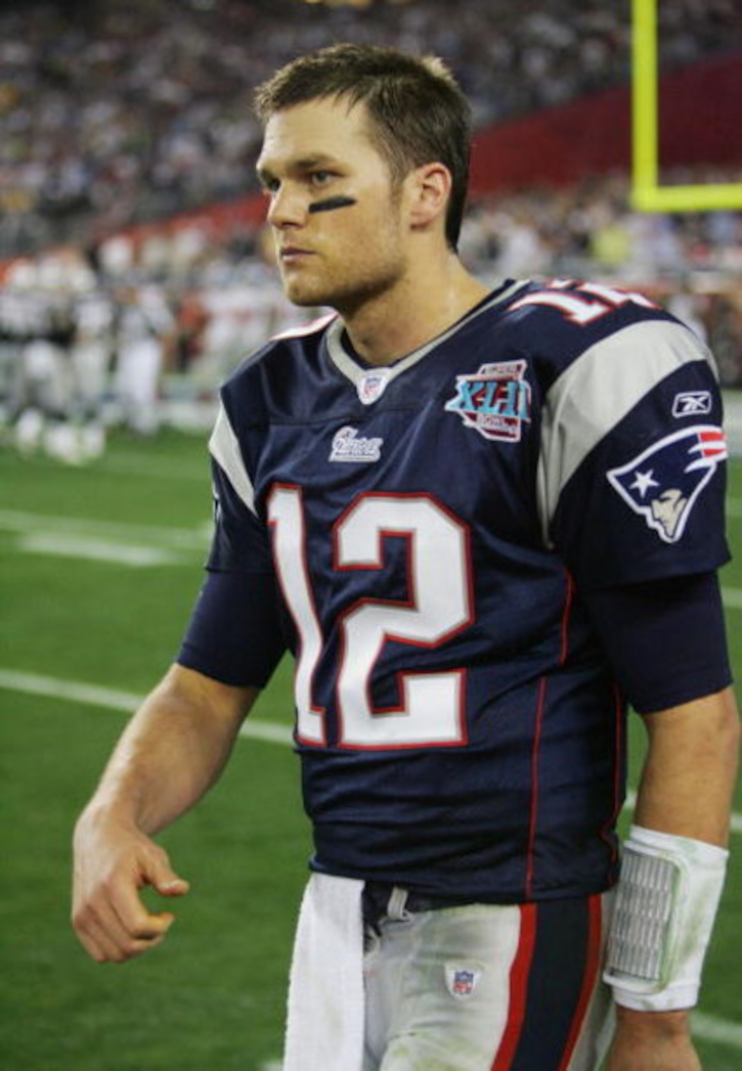 GLENDALE, AZ - FEBRUARY 03:  Tom Brady #12 of the New England Patriots walks off the field after connecting with Randy Moss for a touchdown in the fourth quarter against the New York Giants during Super Bowl XLII on February 3, 2008 at the University of P