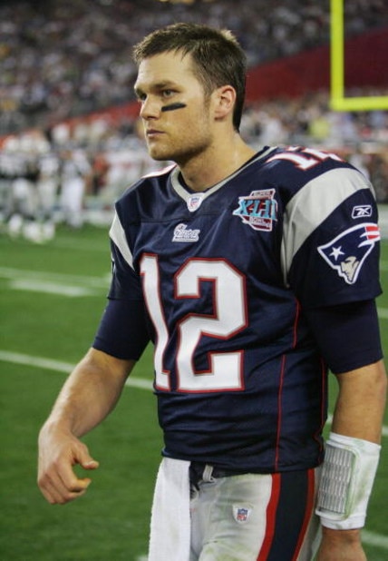 GLENDALE, AZ - FEBRUARY 03:  Tom Brady #12 of the New England Patriots walks off the field after connecting with Randy Moss for a touchdown in the fourth quarter against the New York Giants during Super Bowl XLII on February 3, 2008 at the University of P