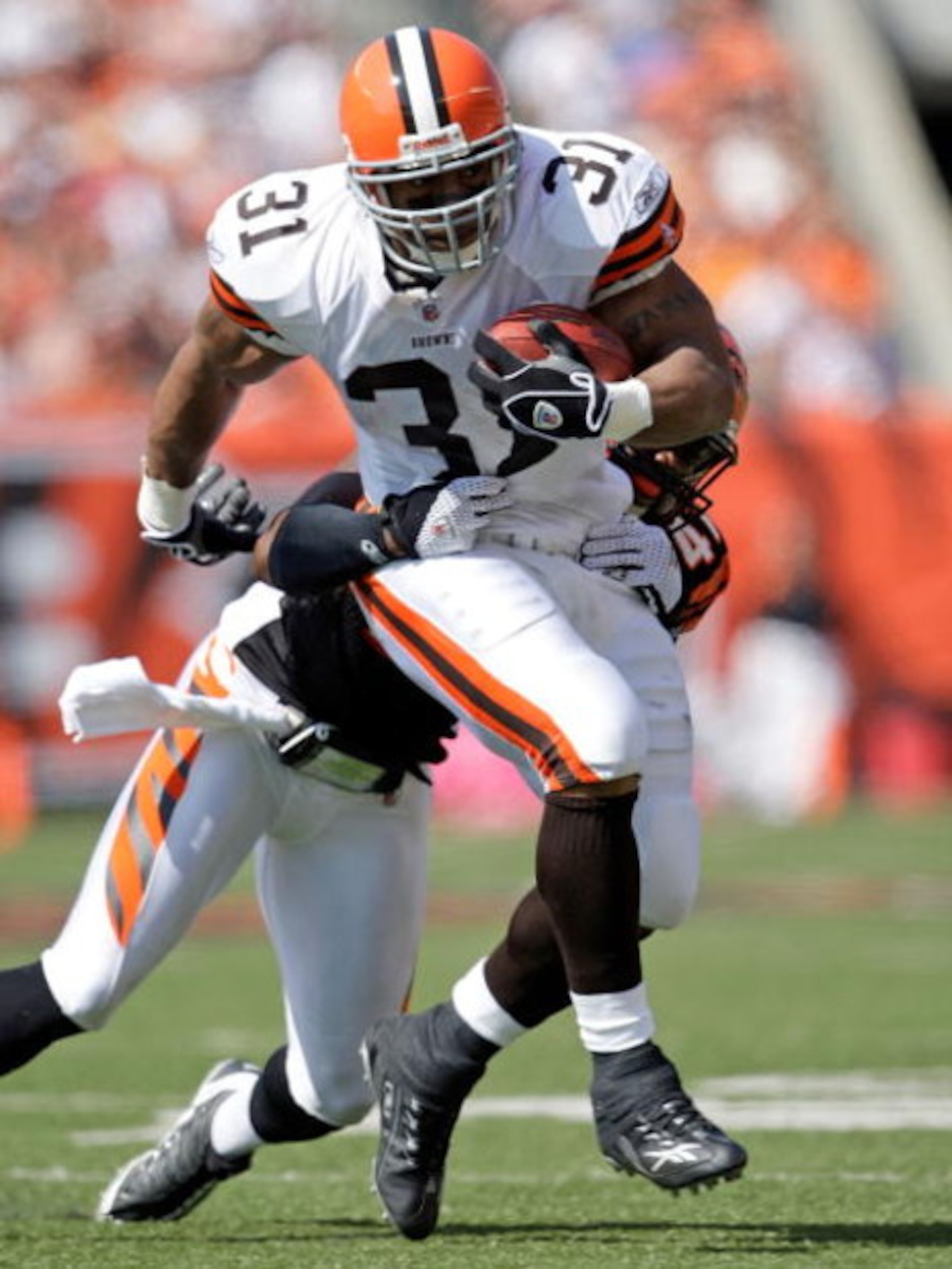 CINCINNATI - SEPTEMBER 28:  Jamal Lewis #31 of the Cleveland Browns runs with the ball while defended by Chinedum Ndukwe #41 of the Cincinnati Bengals during the NFL game against on September 28, 2008 at Paul Brown Stadium in Cincinnati, Ohio.  (Photo by 