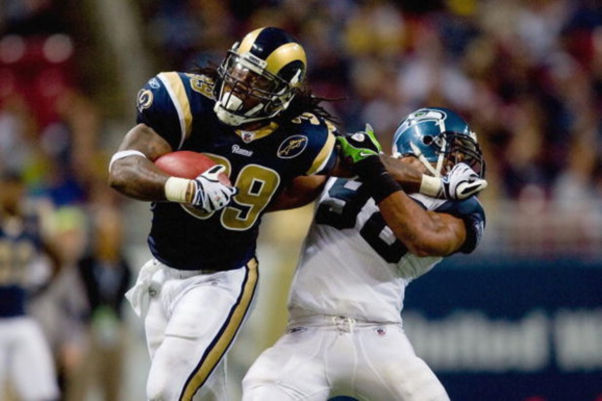 ST. LOUIS, MO - DECEMBER 14:  Steven Jackson #39 of the St. Louis Rams carries the ball as he blocks Julian Peterson #98 of the Seattle Seahawks at the Edward Jones Dome on December 14, 2008 in St. Louis, Missouri.  (Photo by: Dilip Vishwanat/Getty Images