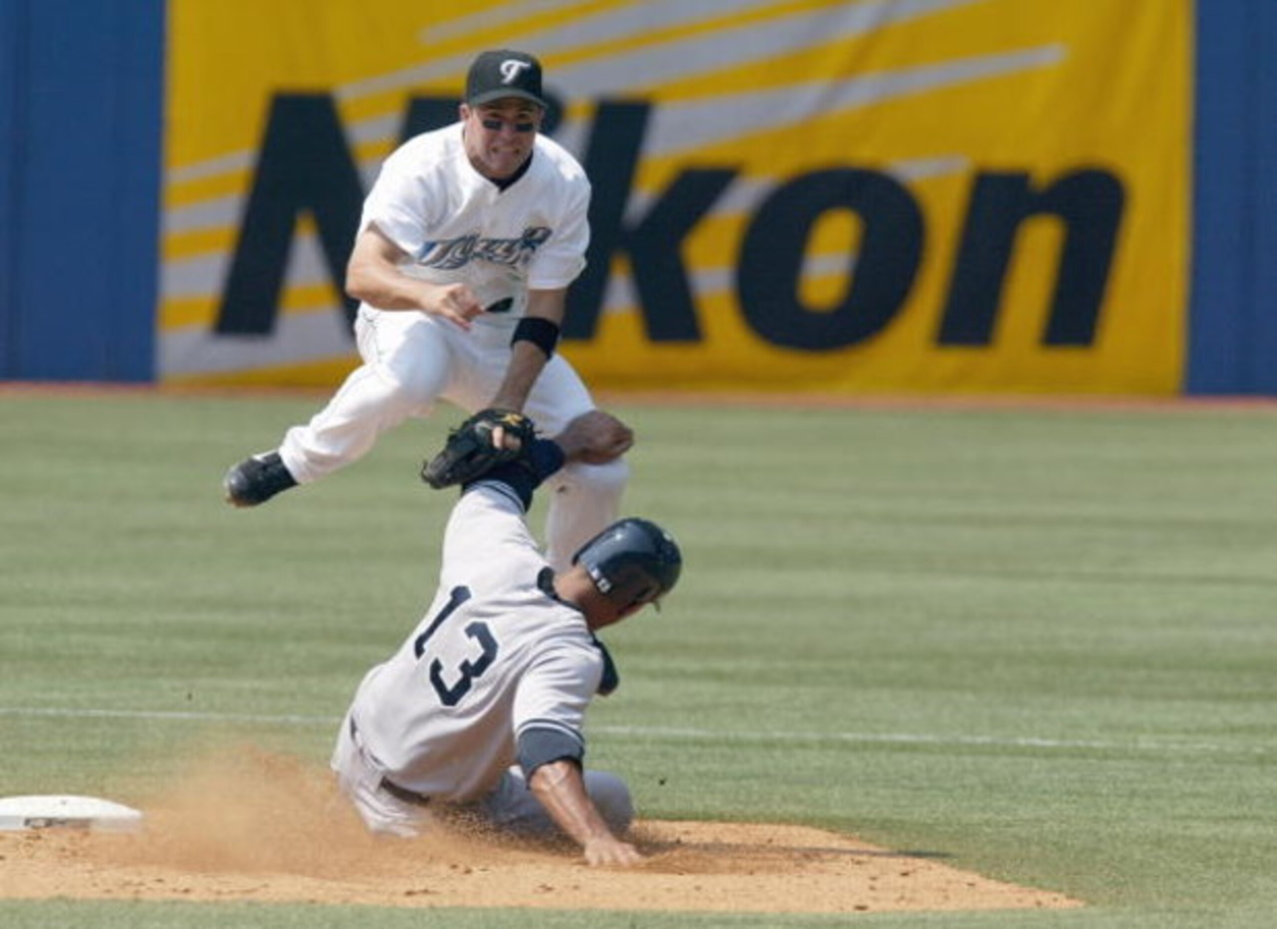TORONTO - AUGUST 6: John McDonald #6 of the Toronto Blue Jays leaps over Alex Rodriguez #13 of the New York Yankees while turning a double play on August 6, 2007 at the Rogers Centre in Toronto, Ontario, Canada. The Yankees defeated the Blue Jays 5-4. (Ph