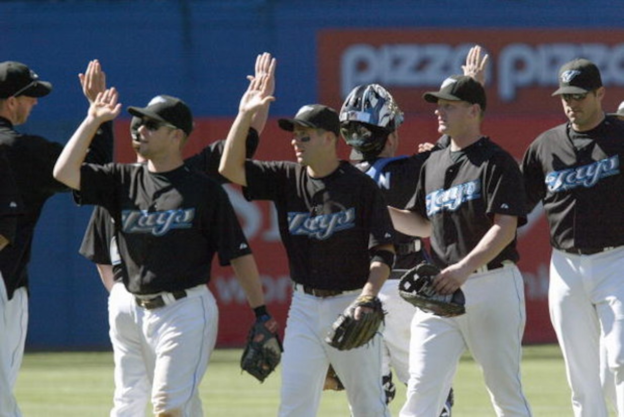 TORONTO - SEPTEMBER 1: John McDonald #6 of the Toronto Blue Jays high fives teammates after the game against the Seattle Mariners during their MLB game at the Rogers Centre September 1, 2007 in Toronto, Ontario.(Photo By Dave Sandford/Getty Images) 