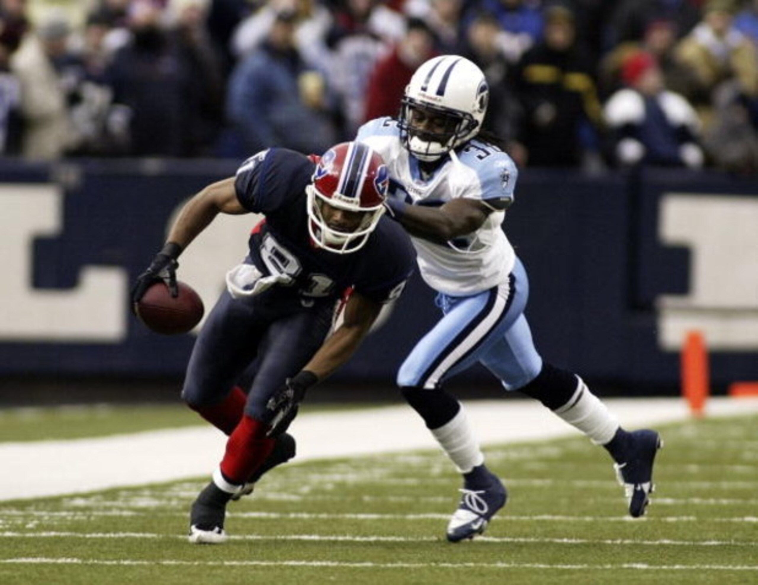 ORCHARD PARK, NY - DECEMBER 24:  Pacman Jones #32 of the Tennessee Titans gets a grip on Peerless Price #81 of the Buffalo Bills on December 24, 2006 at Ralph Wilson Stadium in Orchard Park, New York. Tennessee defeated Buffalo, 30-29.  (Photo by Rick Ste