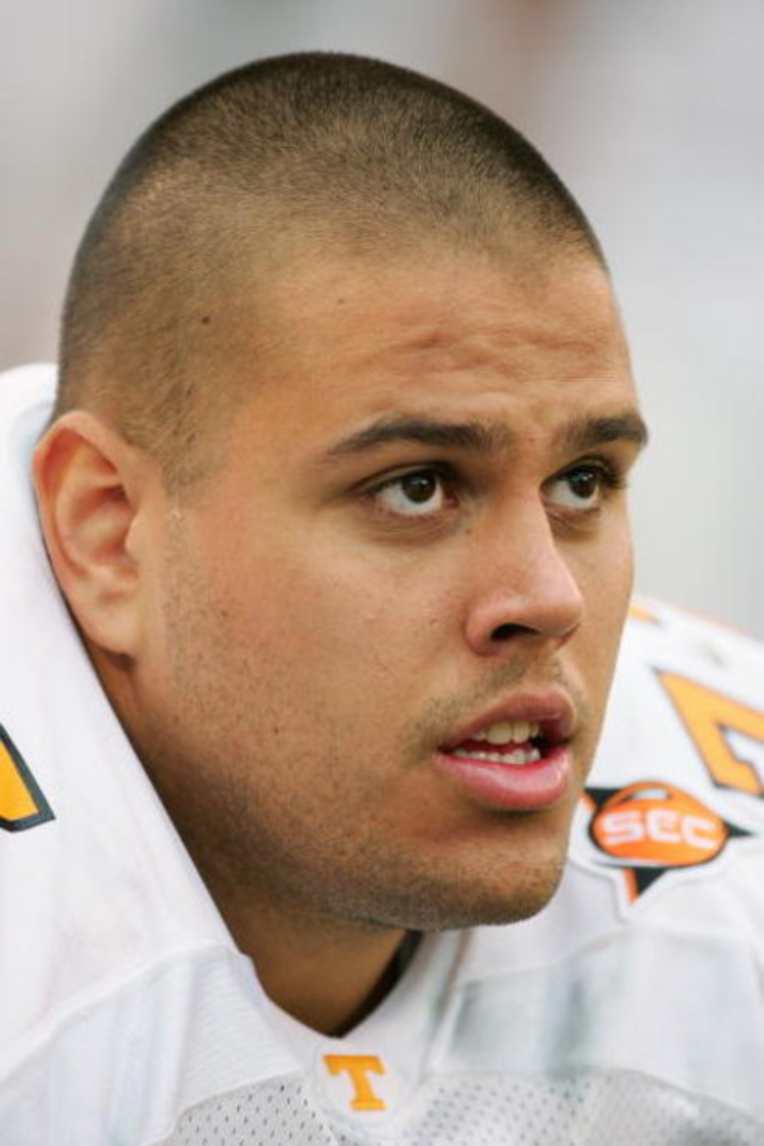ATHENS, GA - OCTOBER 9:  Michael Munoz #77 of the Tennessee Volunteers looks on from the bench during the game against the Georgia Bulldogs at Sanford Stadium on October 9, 2004 in Athens, Georgia.  Tennessee won 19-14.  (Photo by Scott Halleran/Getty Ima