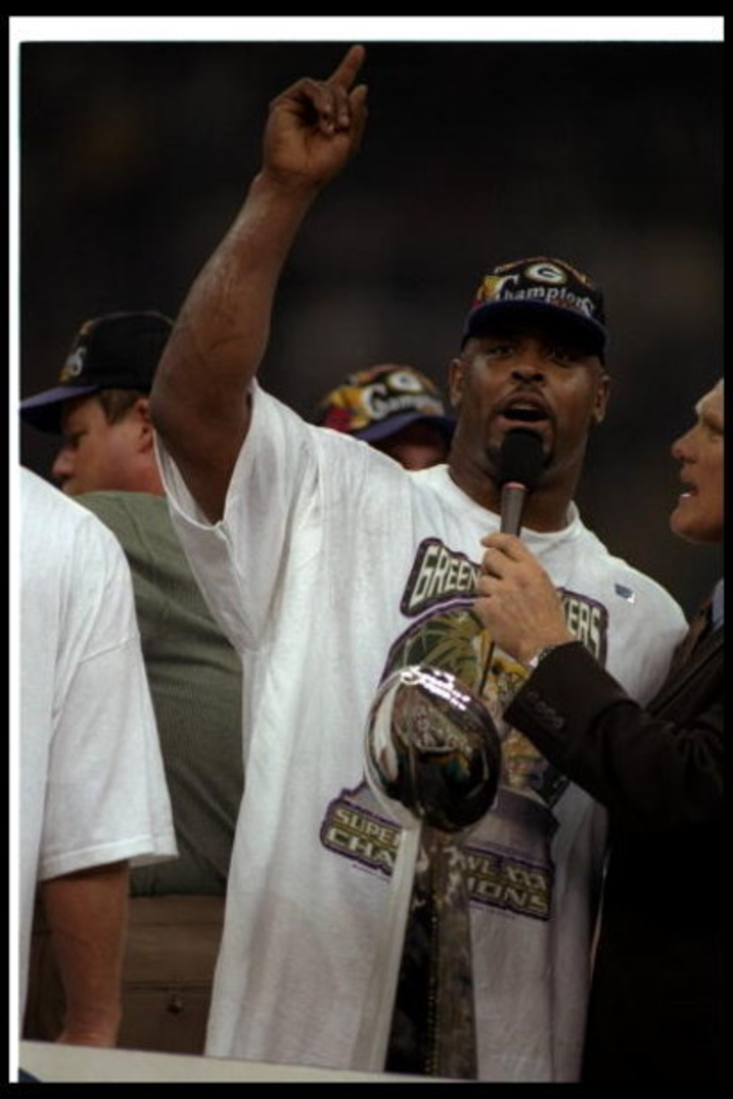 26 Jan 1997:  Defensive lineman Reggie White of the Green Bay Packers gets interviewed by FOX Sports commentator and Hall of Fame quarterback Terry Bradshaw after Super Bowl XXXI against the New England Patriots at the Superdome in New Orleans, Louisiana.